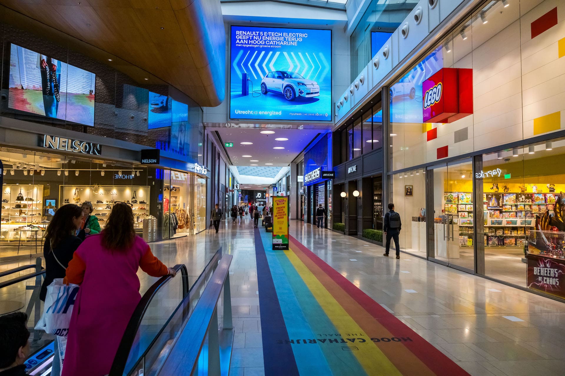 A shoppingmall with a mywheels advertisement on a big screen