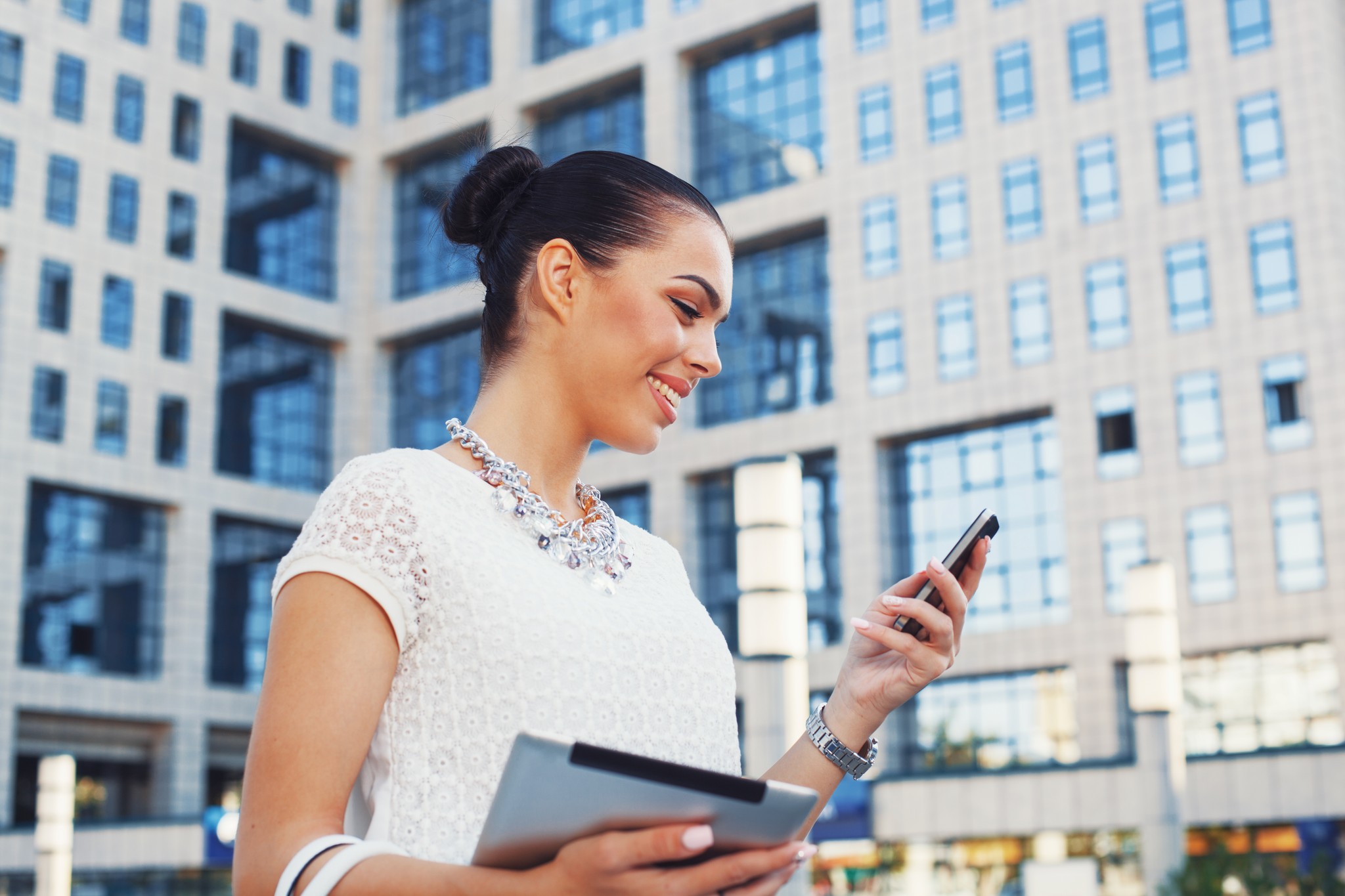 Business Woman Using Phone Outside Office Building