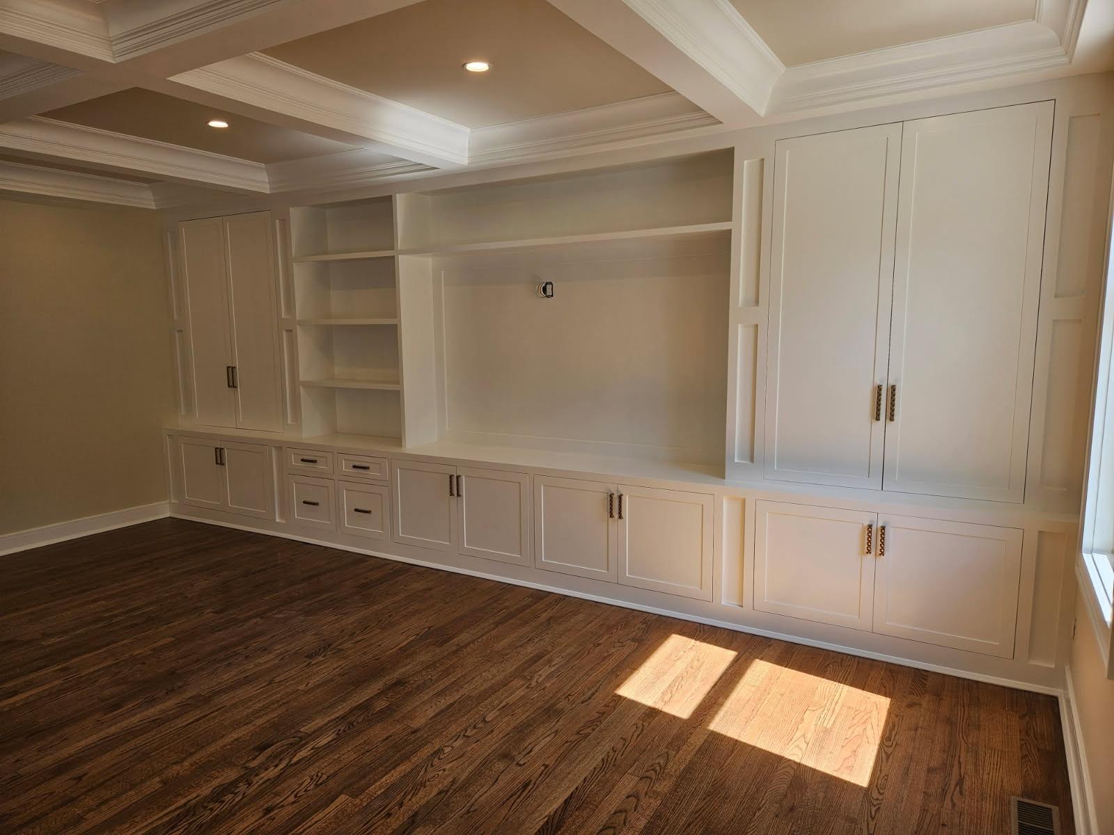 Custom built-in cabinetry with shelving and storage in finished living space
