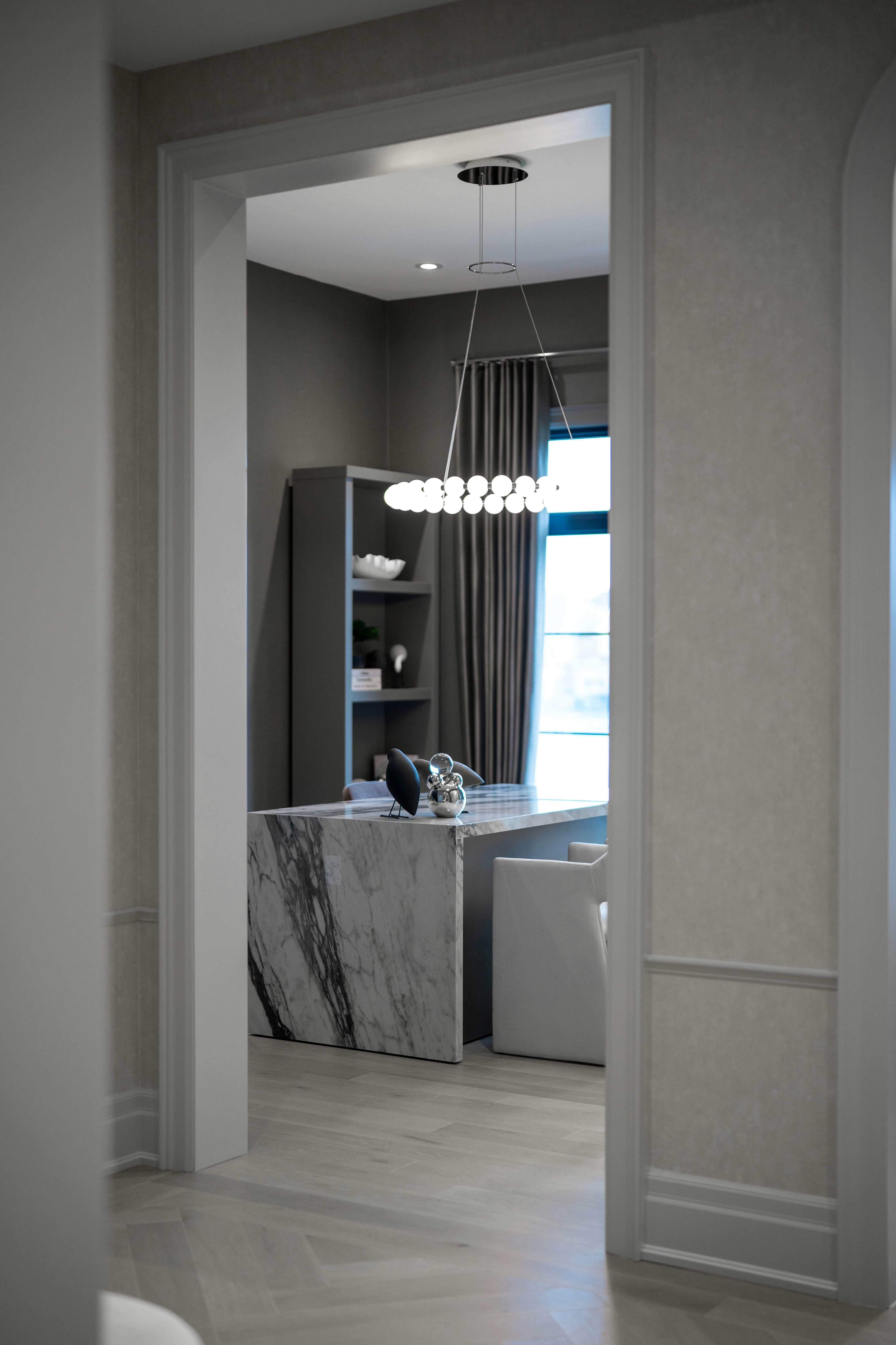 Modern office with marble desk and contemporary chandelier