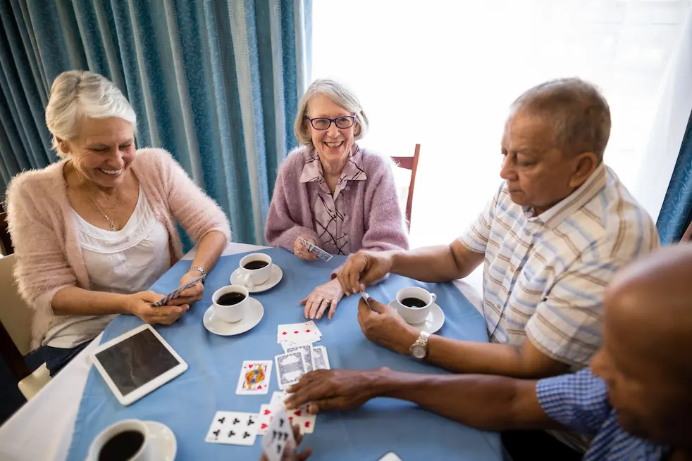 senior friends playing cards