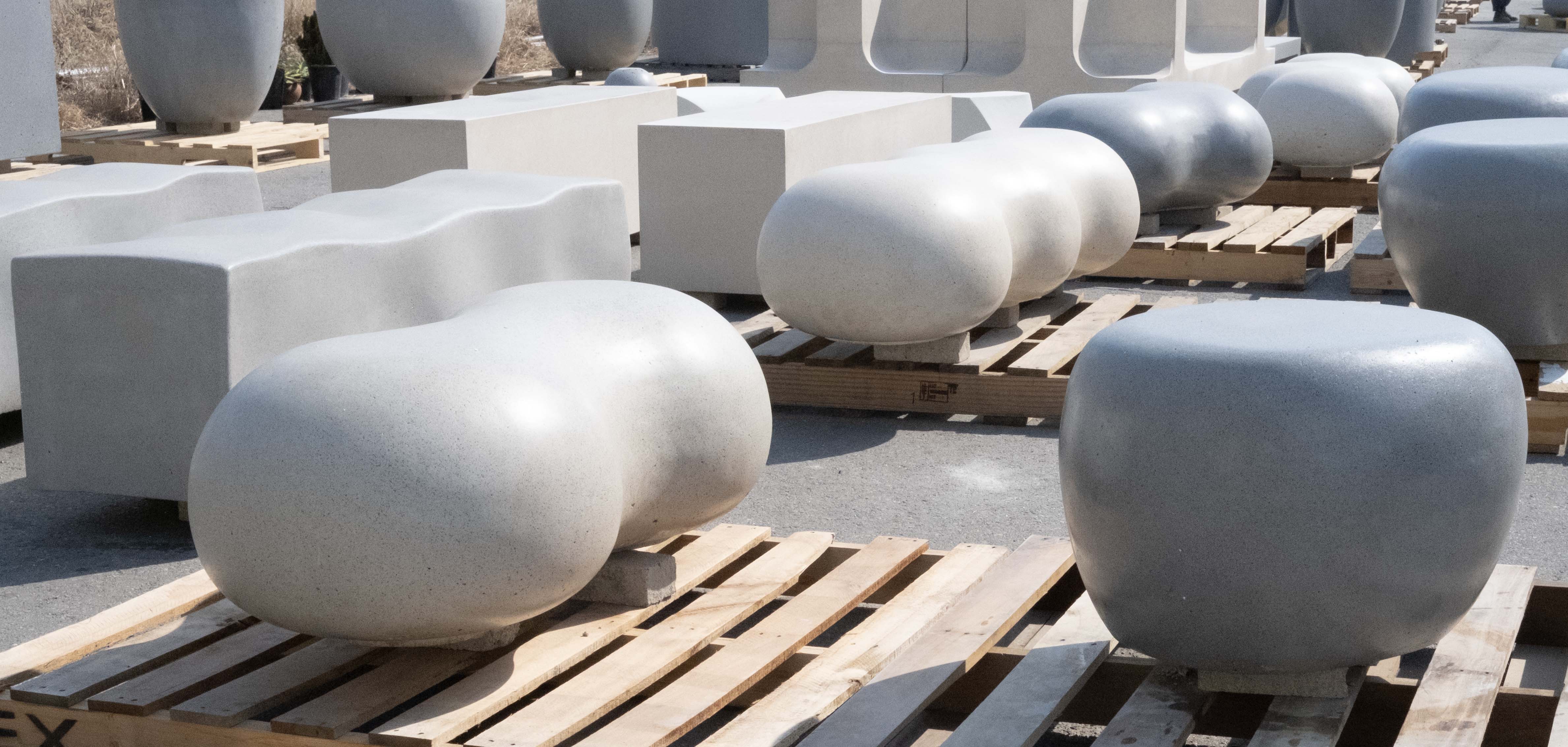 Abstract macro of a glass drop forming a black-and-white flower shape through light refraction on a soft gray background.