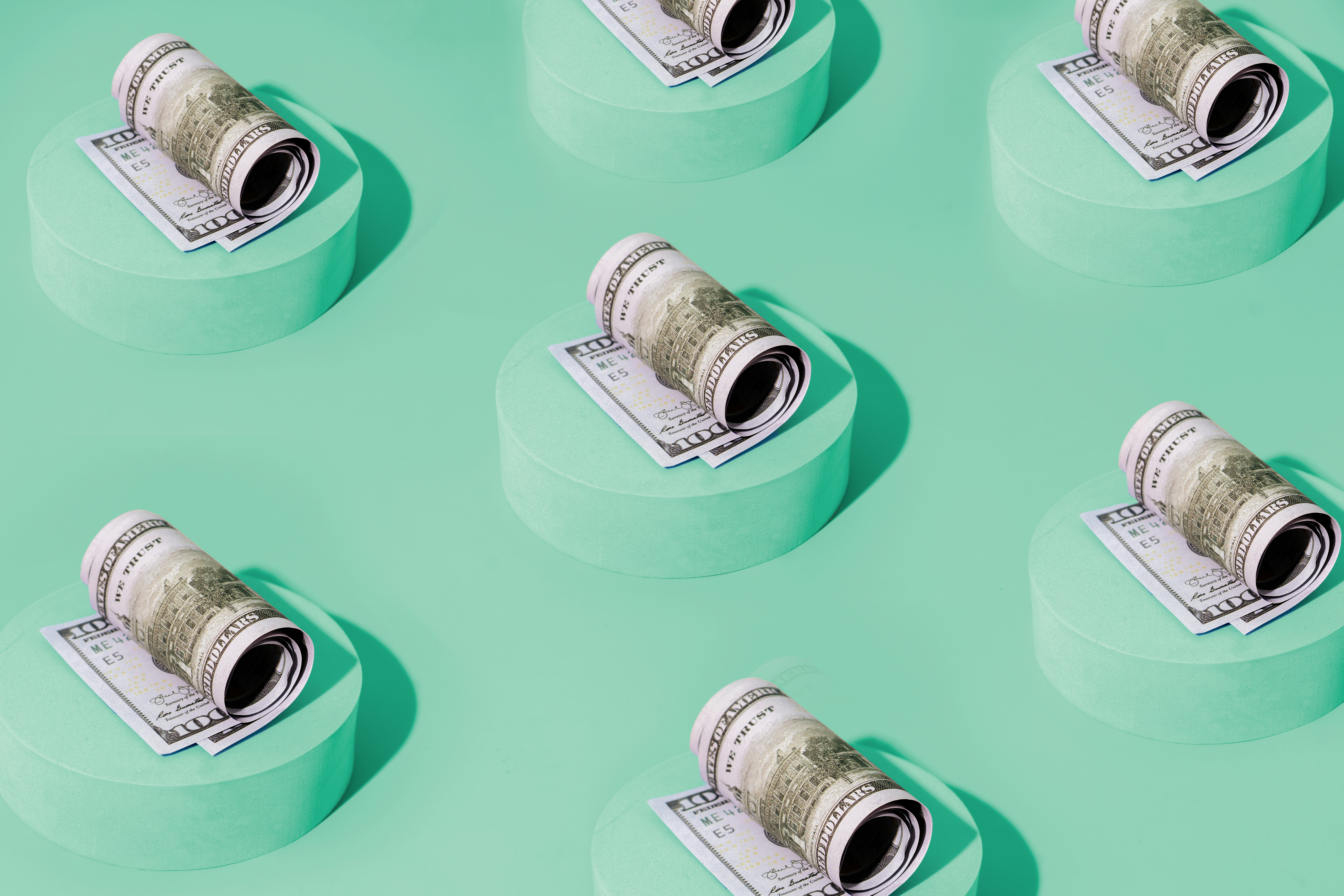 A dollars are organized into piles for different spending categories.