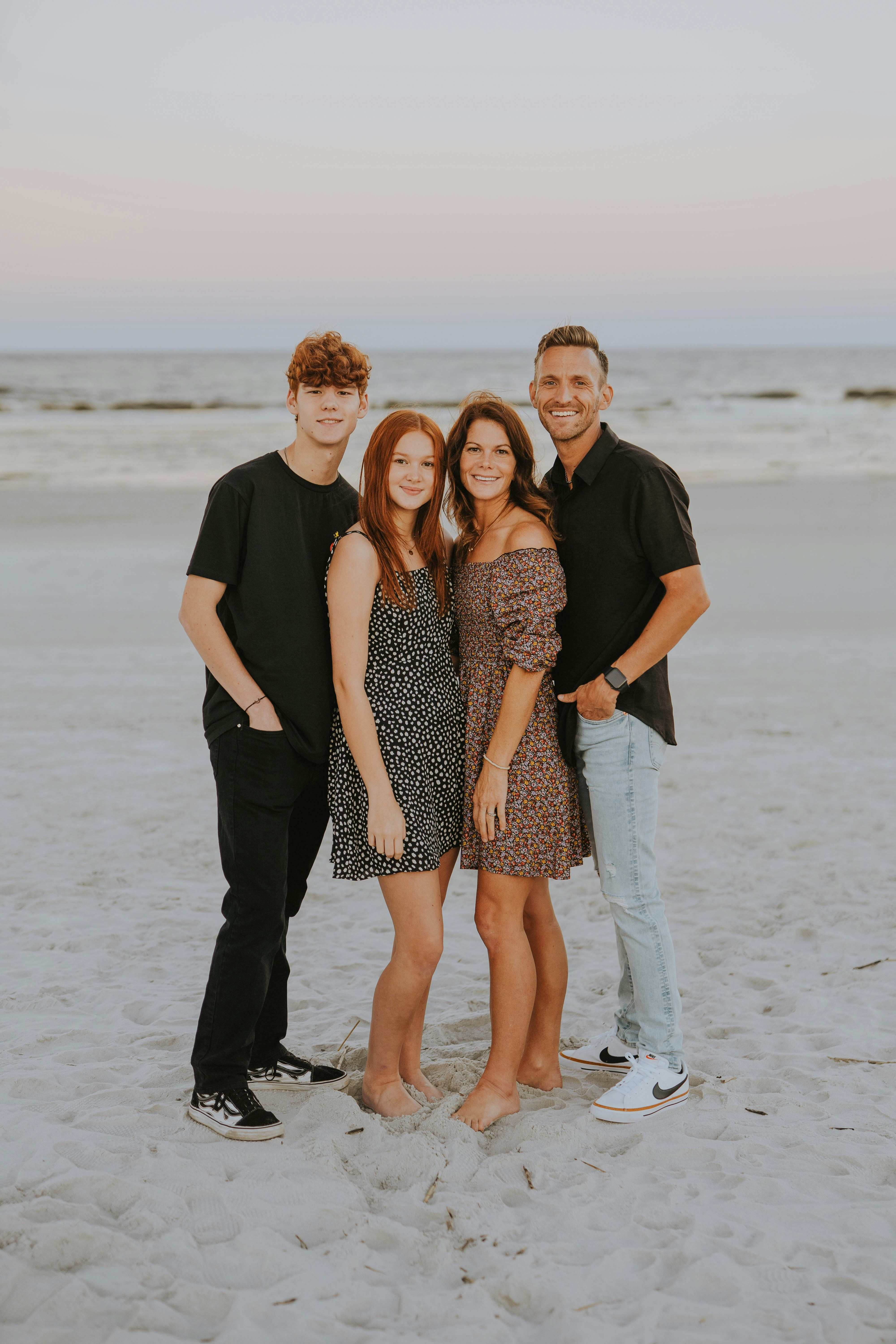 a group of people posing for a photo on a beach