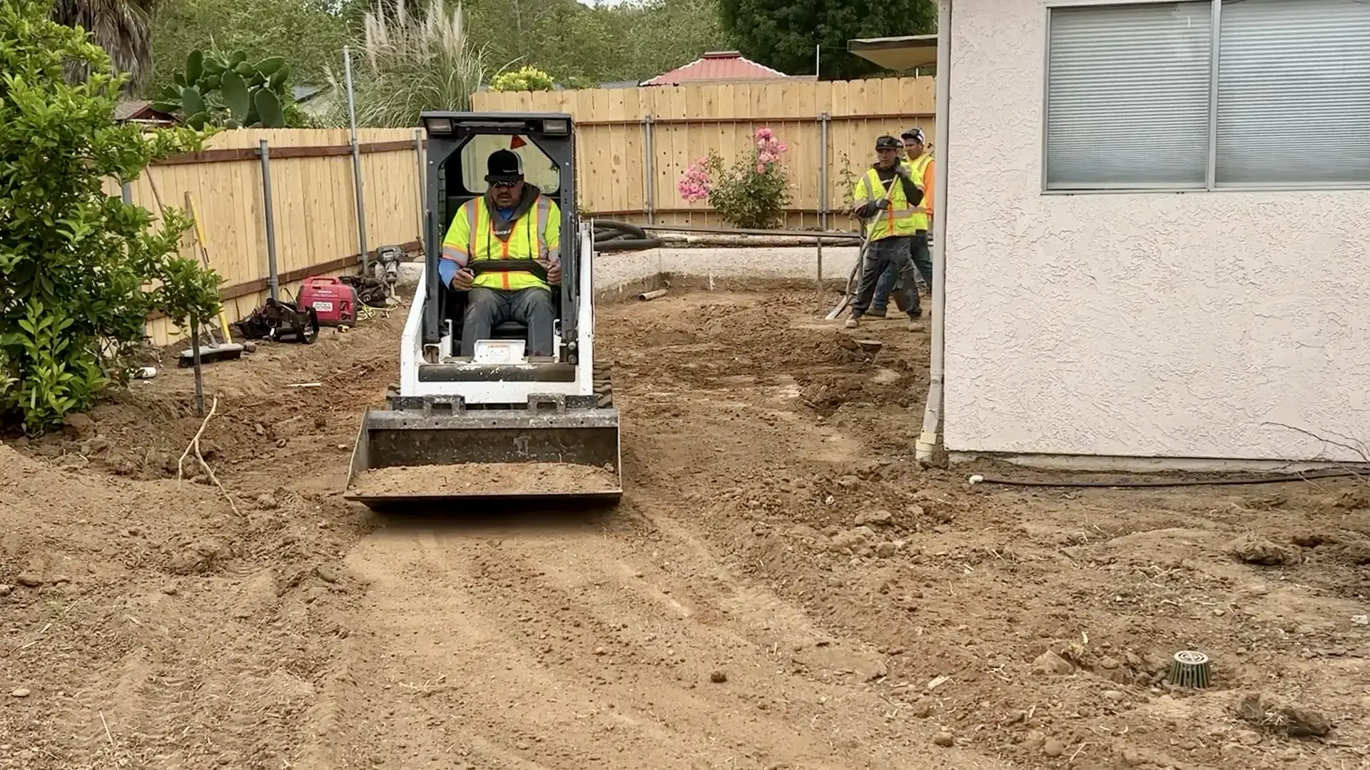 Owner Jose Flores grading the dirt