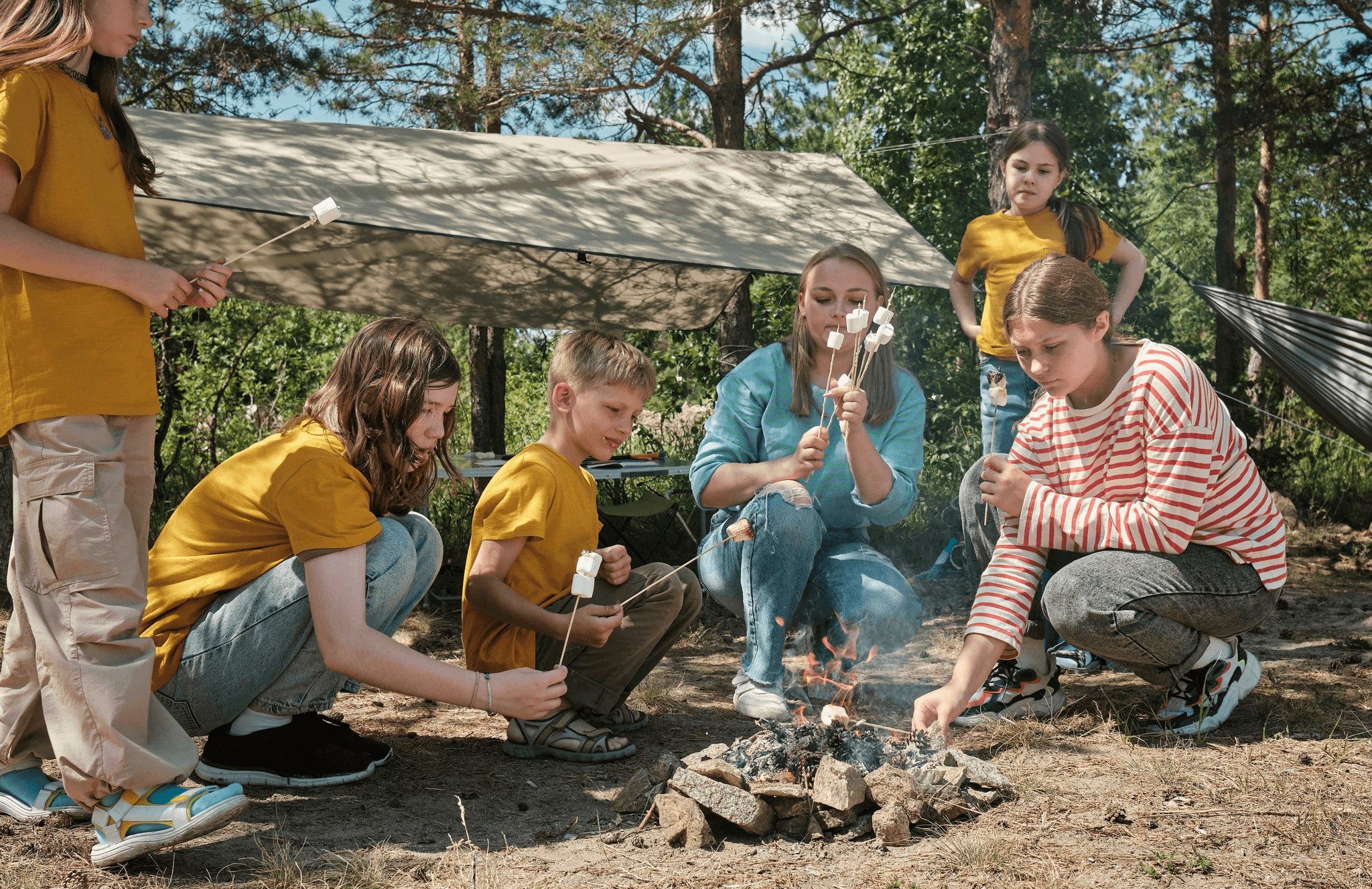 kids toasting marshmallows over a campfire