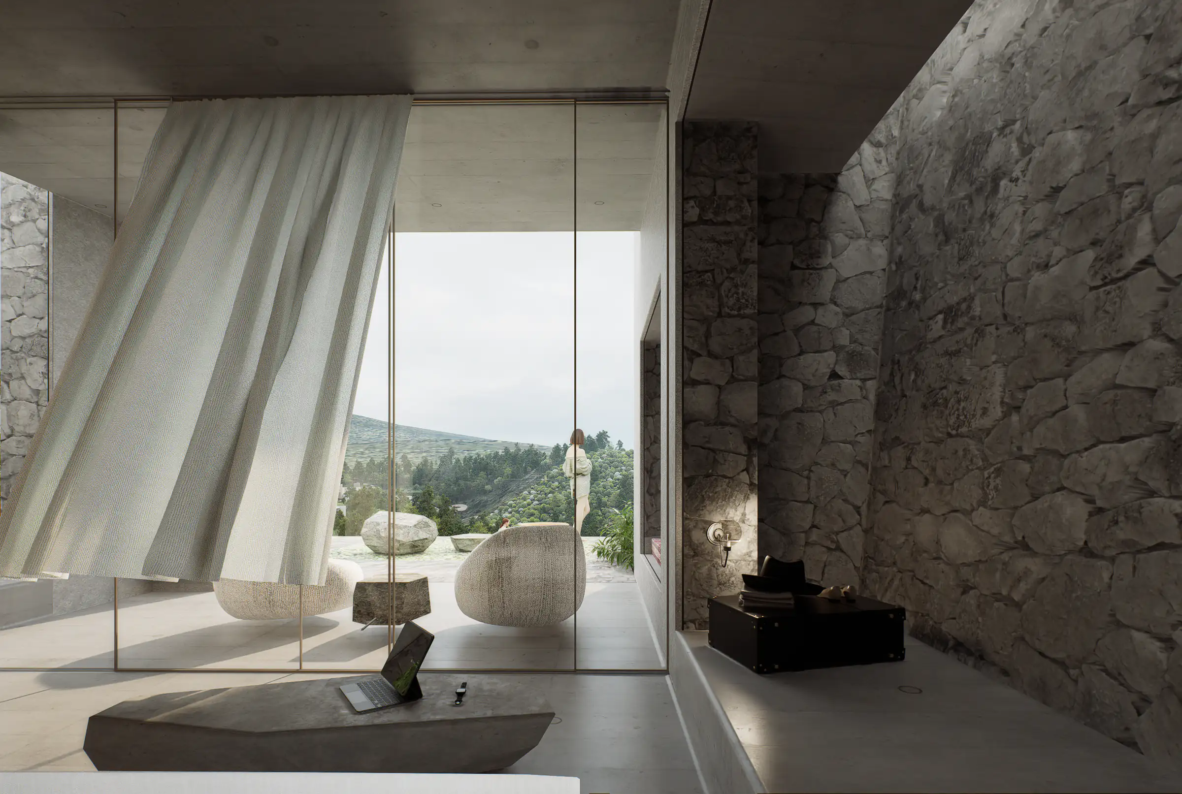 Stone-walled living area with a billowing curtain and a green view beyond the glazing