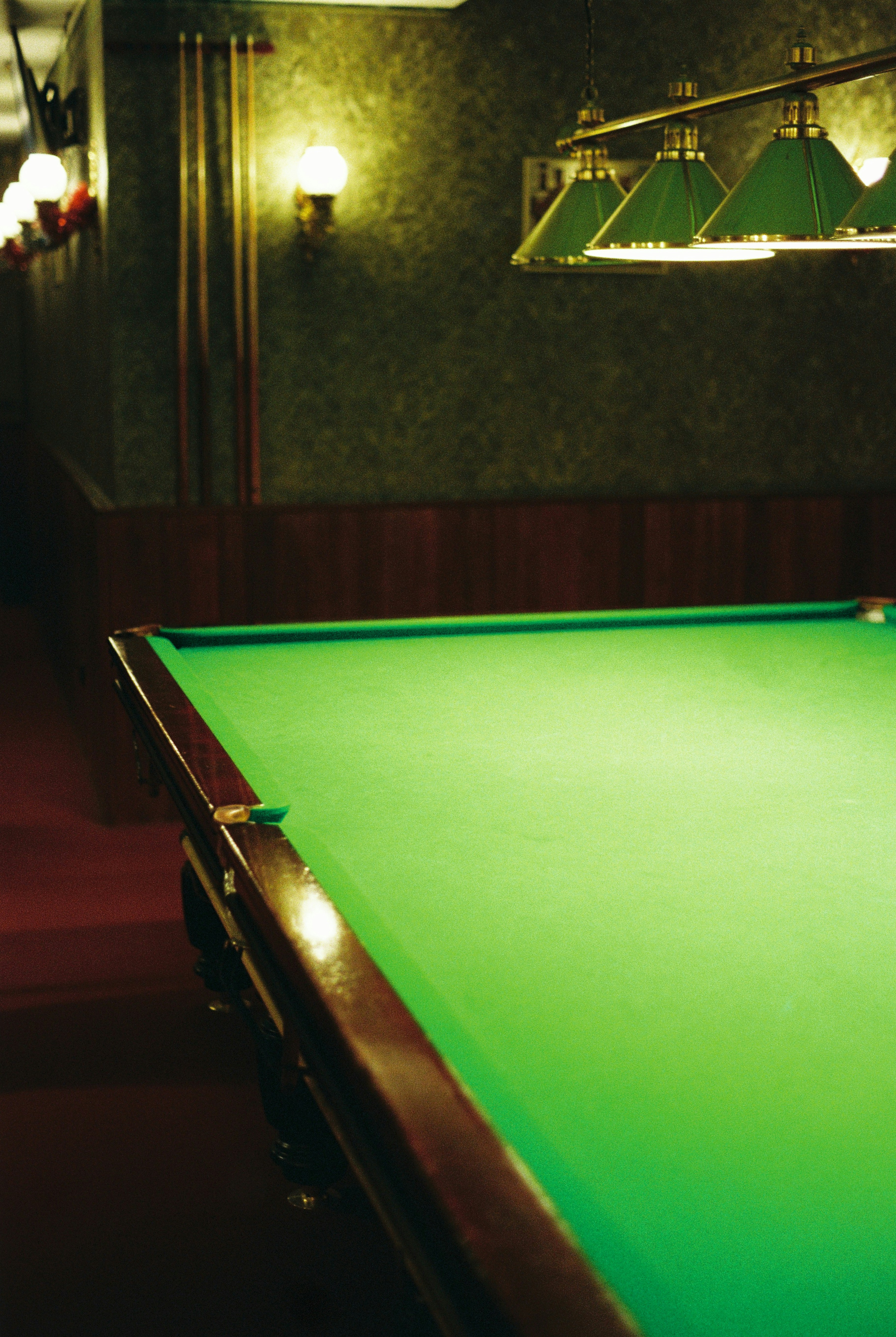 Green billiard table with overhead lights