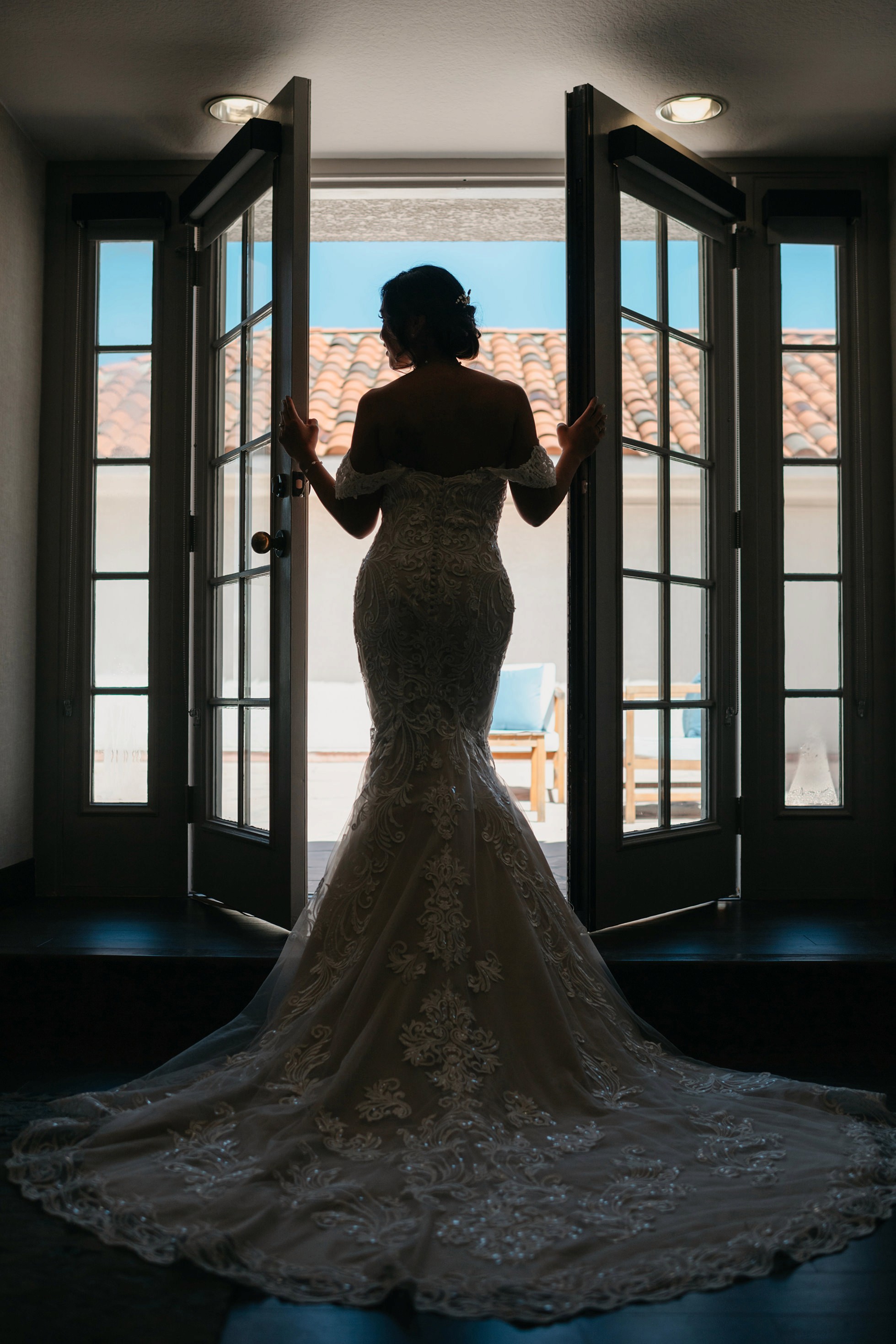 Flat lay wedding details with bouquet, rings, and sparkling bridal heels