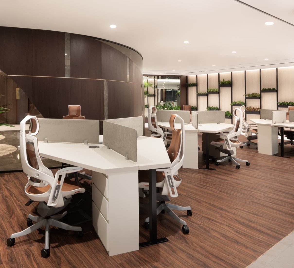 Open-plan coworking space at Al Fattan with minimalist design and contemporary white workstations