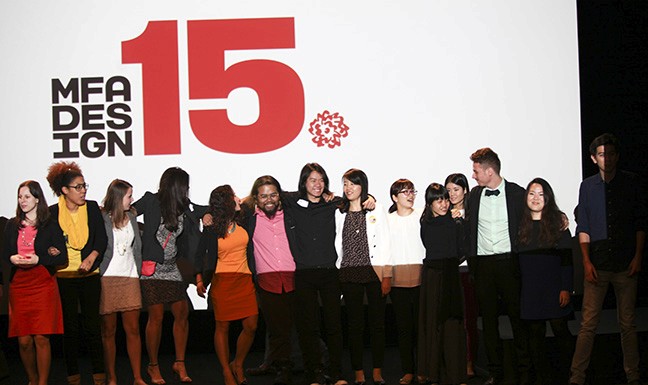 A photo of a group of people on the stage while behind them there is a SVA logo of MFA DESIGN 15.