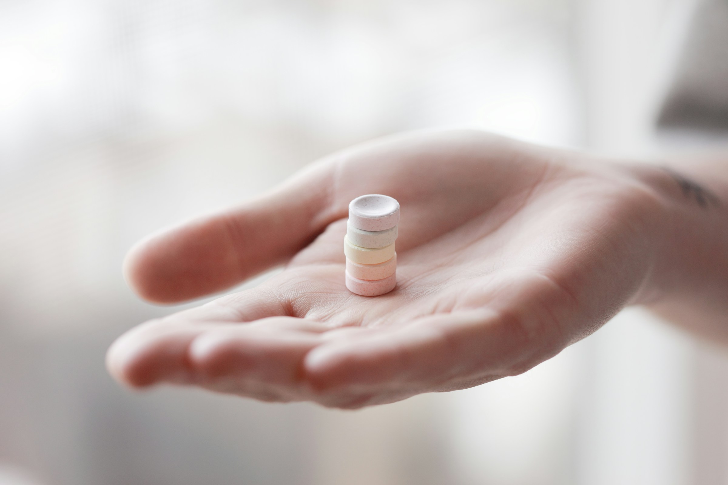 woman holding pills - Best Critical Appraisal Tool for Qualitative Research