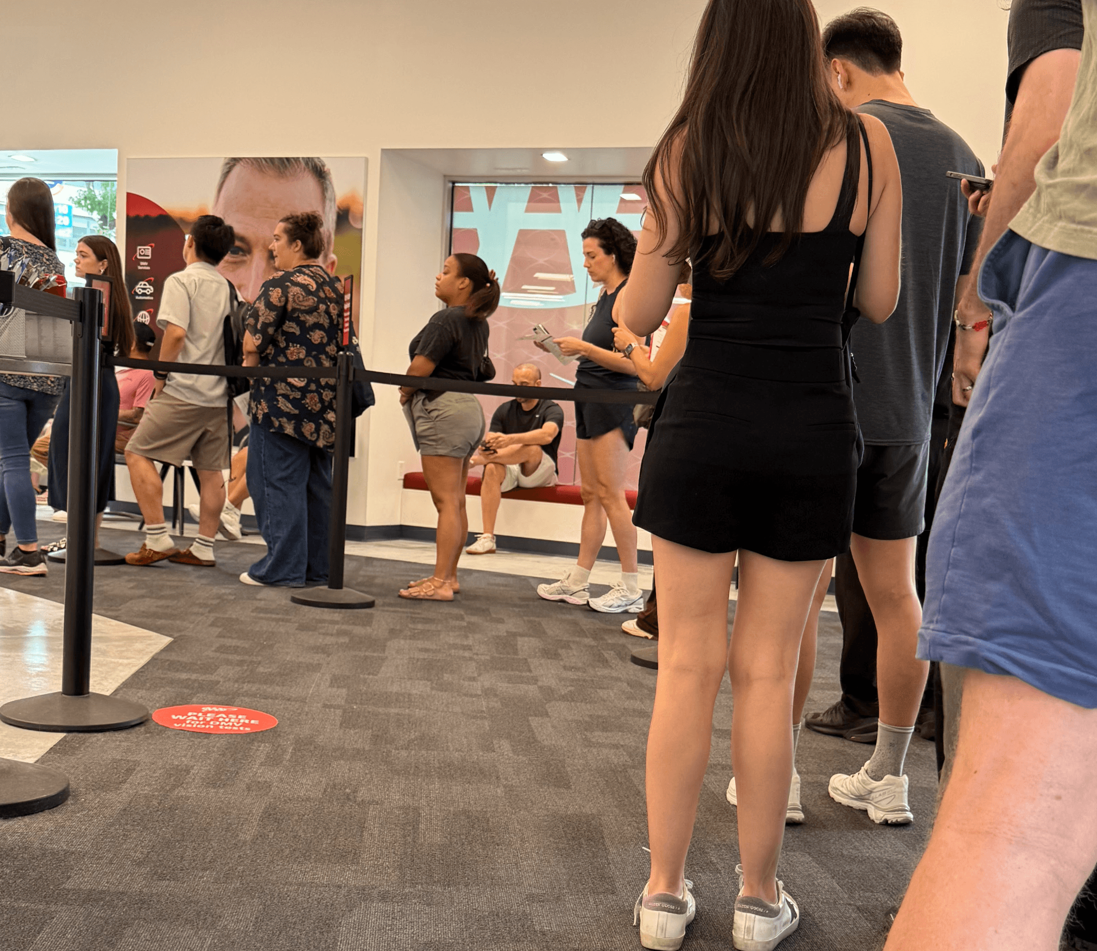 People standing in line at AAA (the American Automobile Association) waiting to get an International Driving Permit (IDP)
