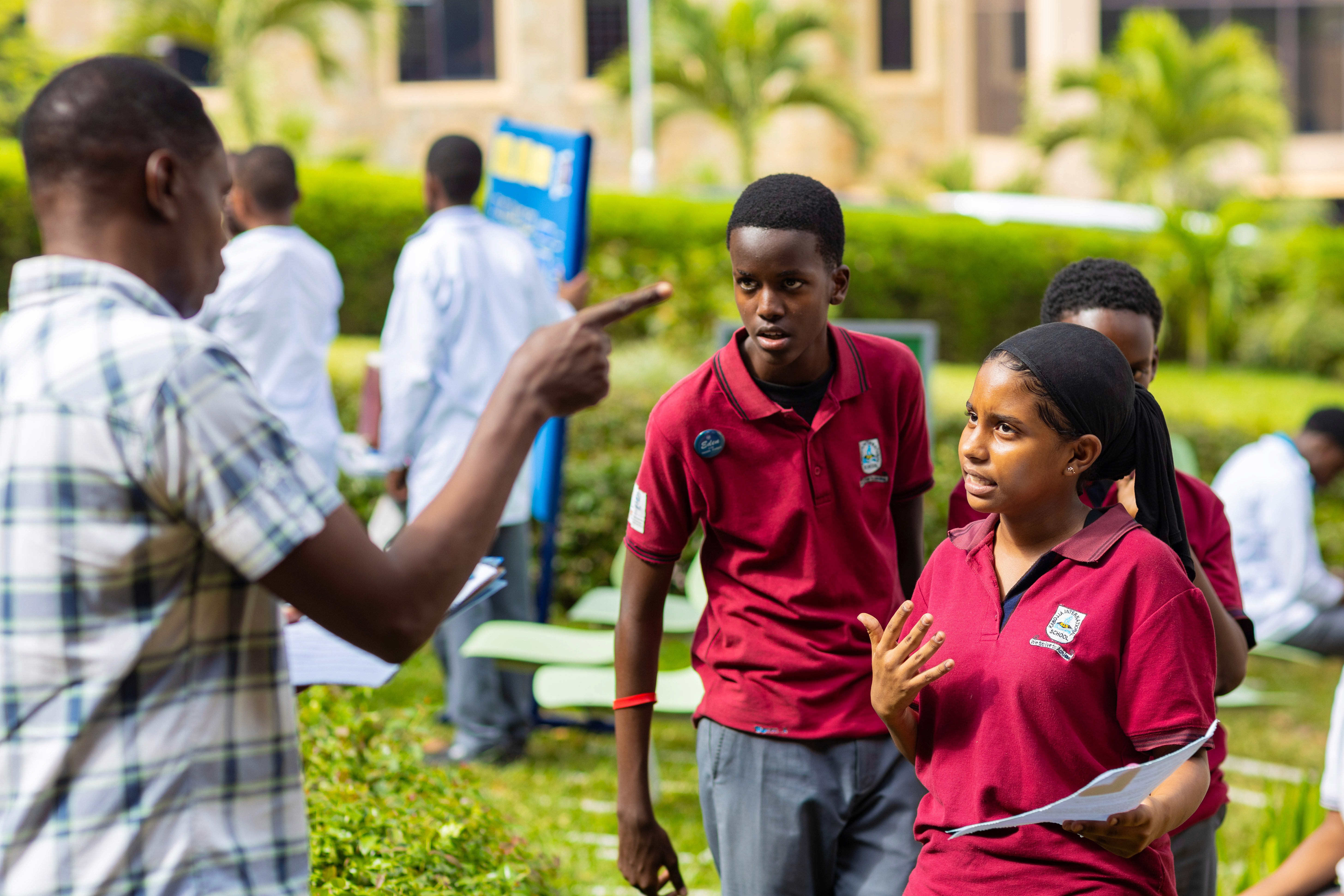 A cheerful student holds a tablet, smiling brightly