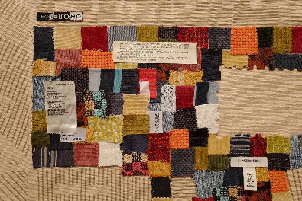 A detail of a textile data artwork visualizing fast fashion waste through a patchwork of used clothing scraps