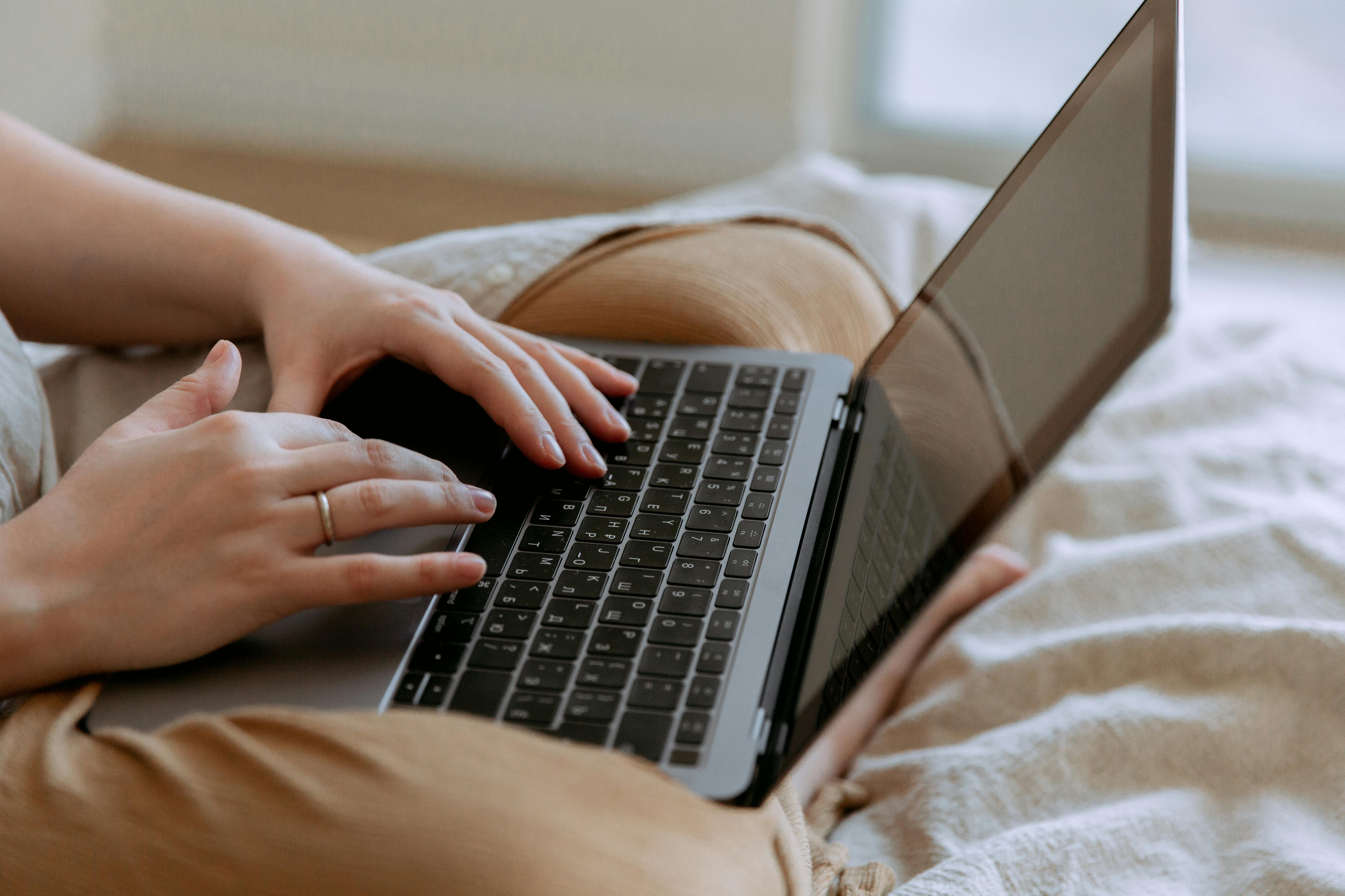 Woman writing cold emails using laptop