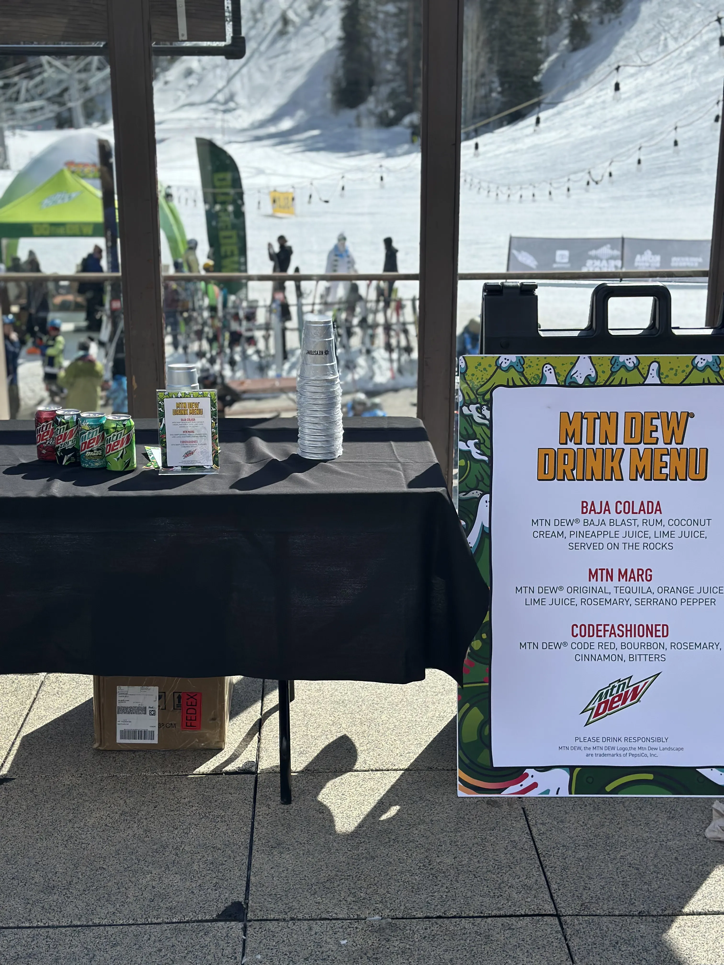 Tasting table at a mountain dew event at a ski mountain base
