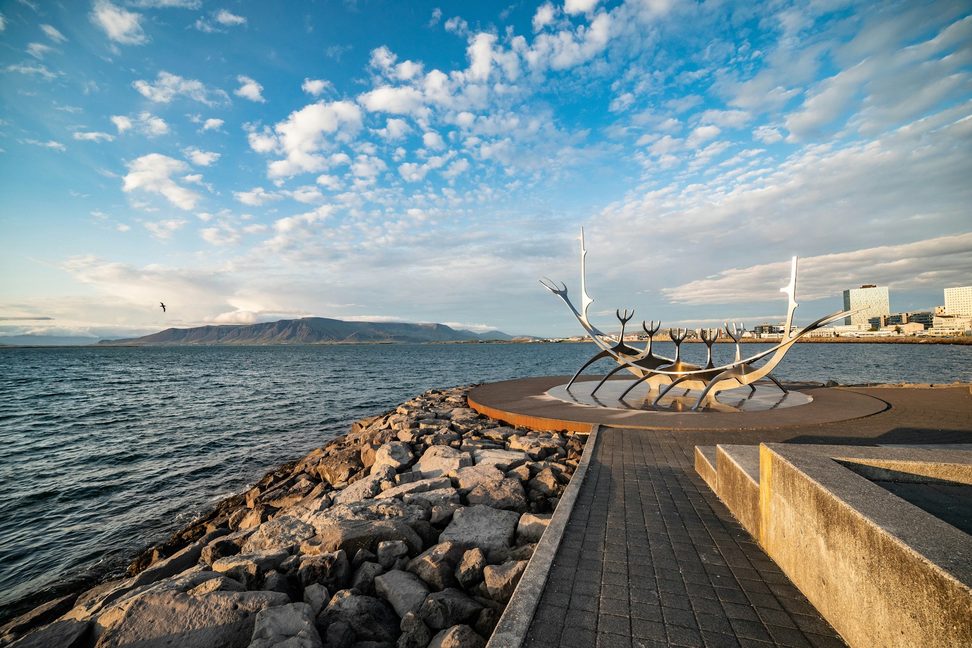 Sun Voyager sculpture on Reykjavík's waterfront overlooking Faxaflói Bay and Mount Esja, Iceland.