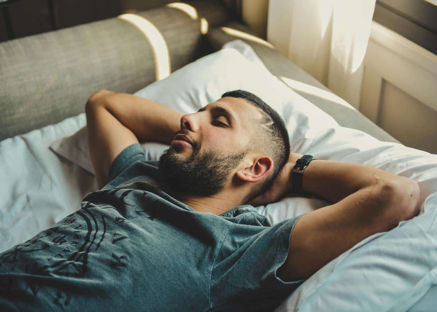 Imprving Sleep Score: Man sleeping on bed