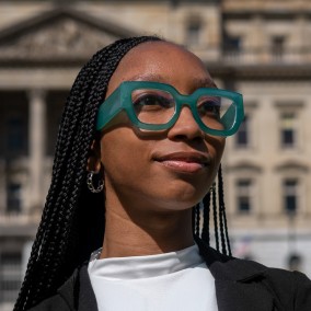 Possible member smiling and looking away from the camera.