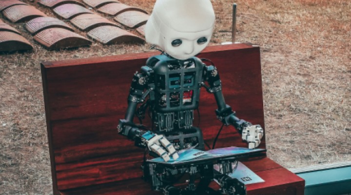 robot is reading by tablet