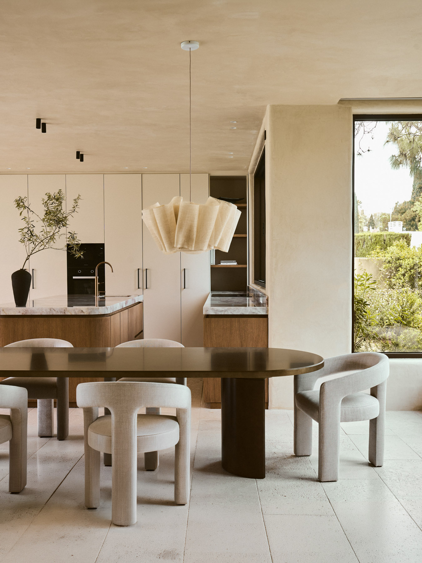 Dining area connected to the garden through large sliding openings.
