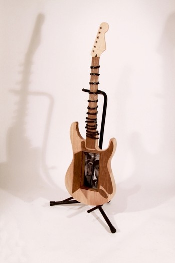 small electric guitar made of wood