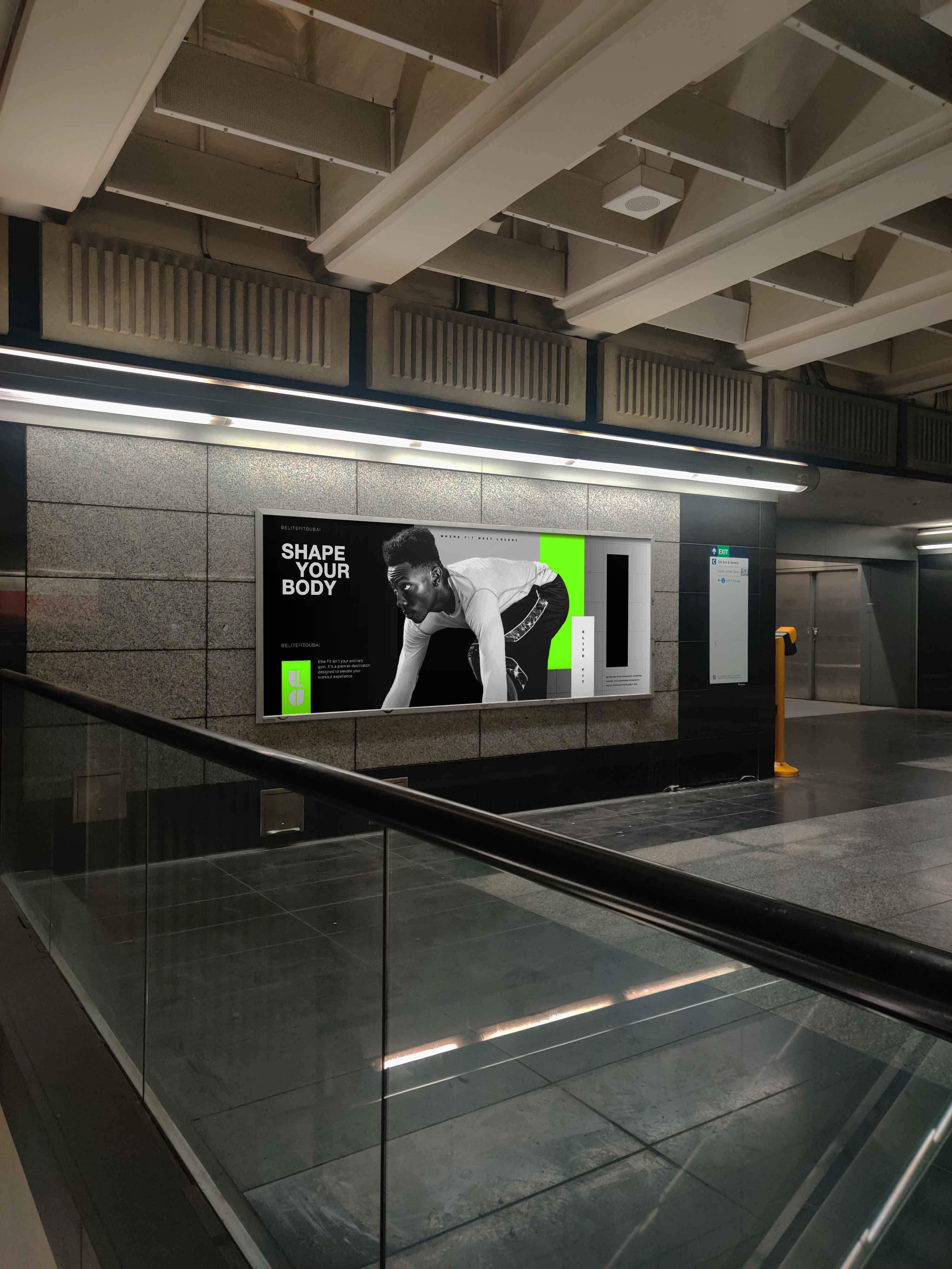 An Elite Fit Poster in subway station with a man wearing sportswear in front of a colorful geometric background.