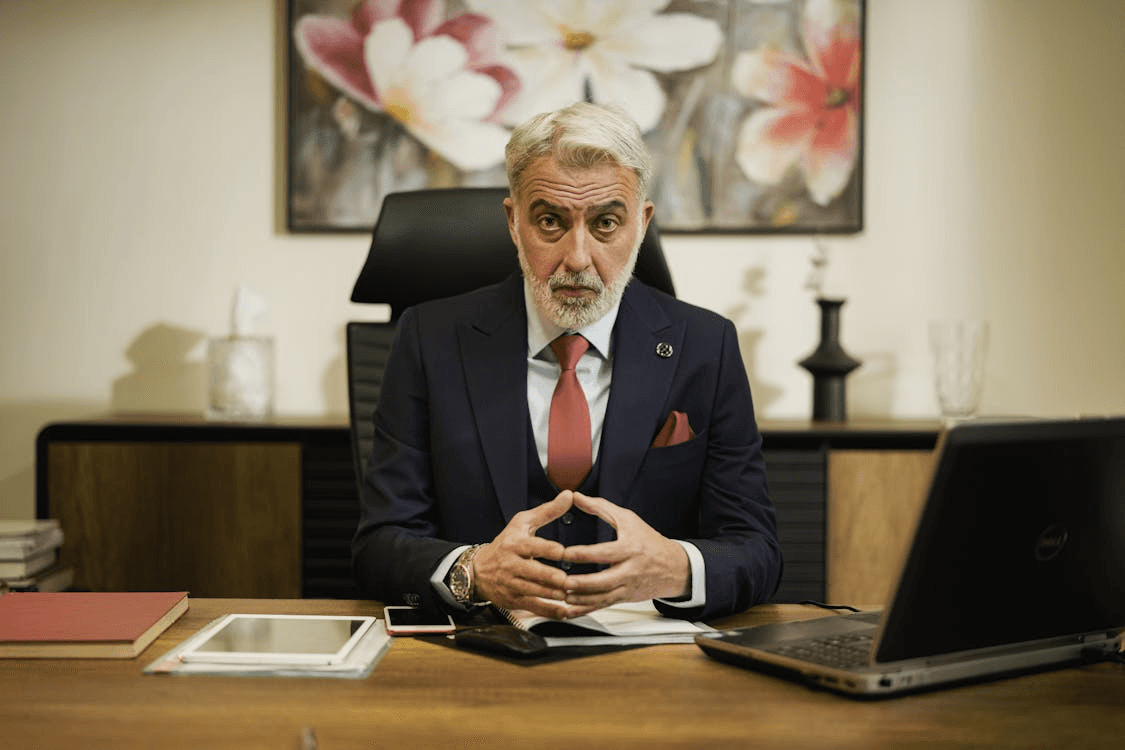 A corporate man wearing suit while seated in office