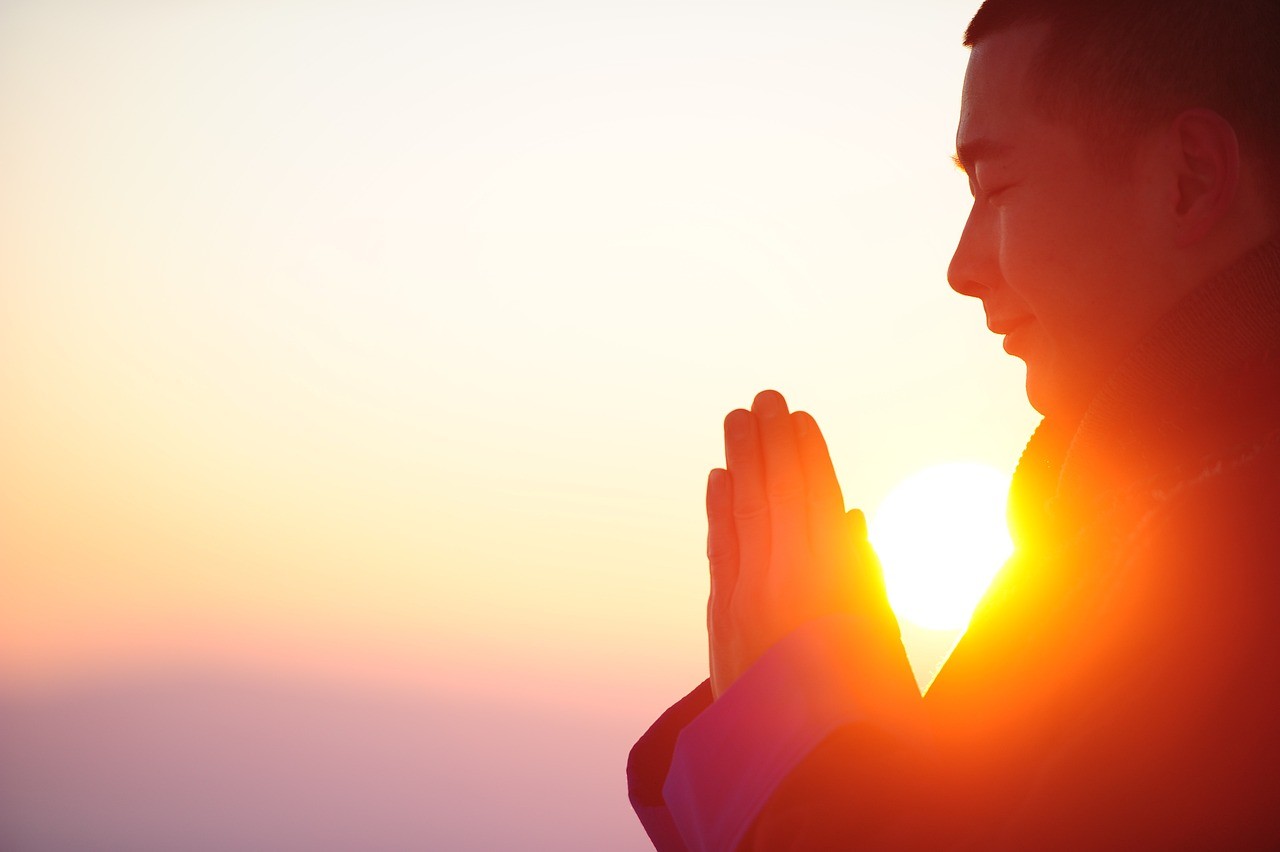 A monk praying during sun set, Heso blog Image
