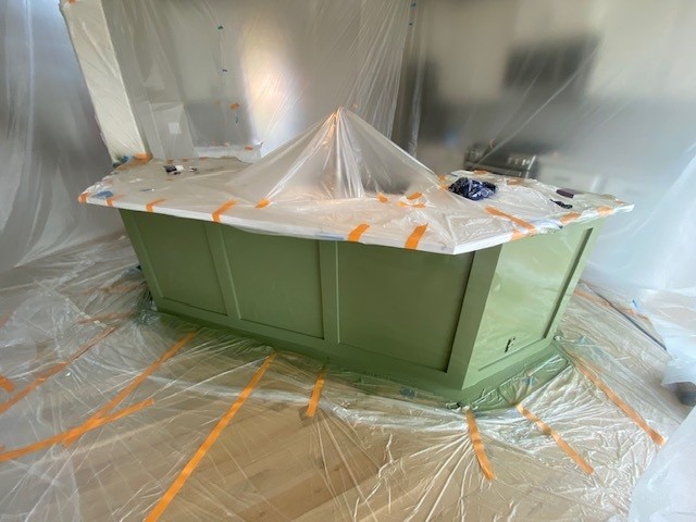 Kitchen island after refinishing in a rich green painted finish.