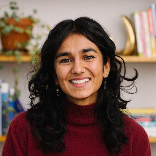 smiling woman wearing white and black pinstriped collared top