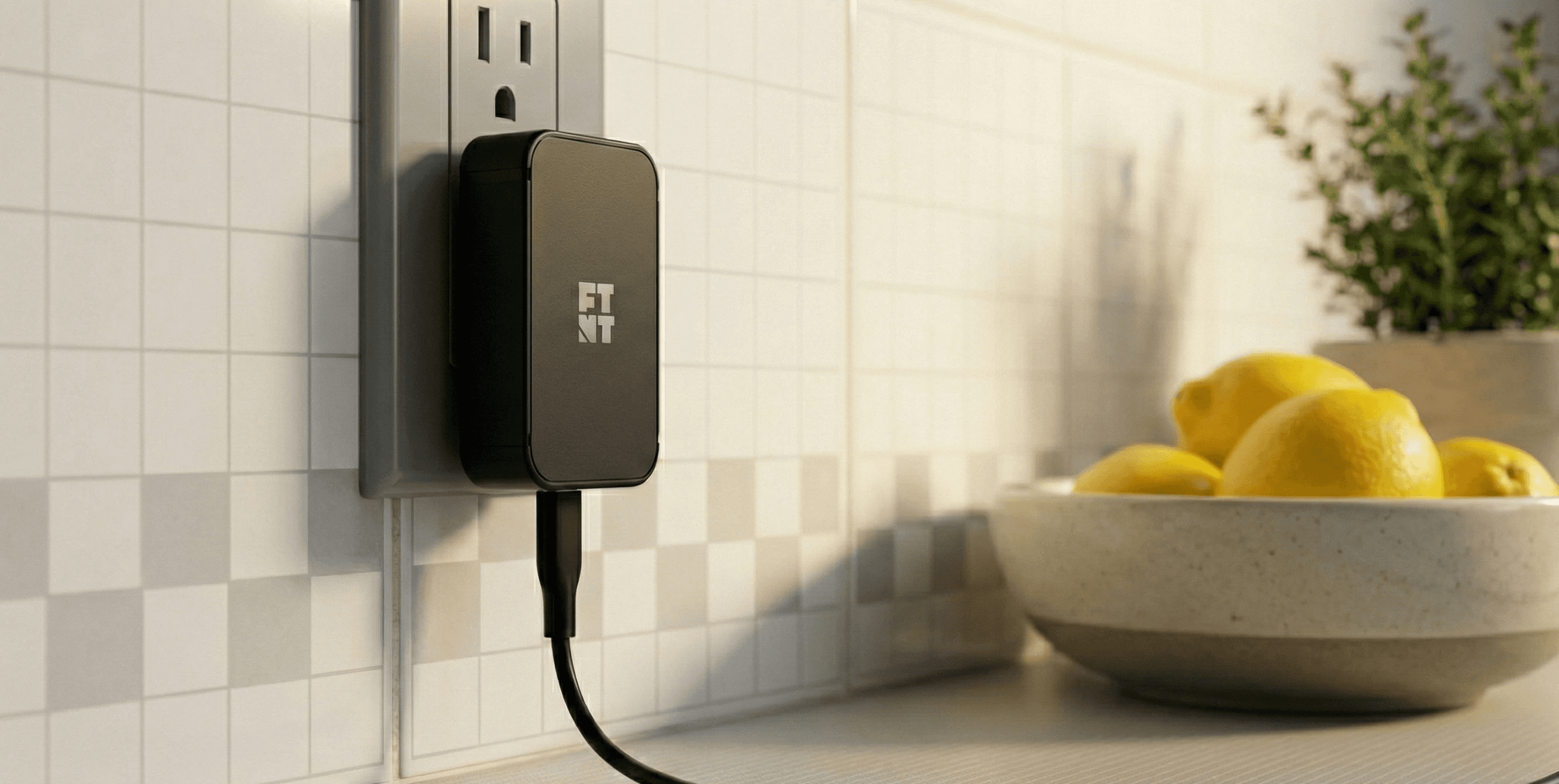 The Footnote Accessories 30W USB-C adapter pluged into a wall outlet