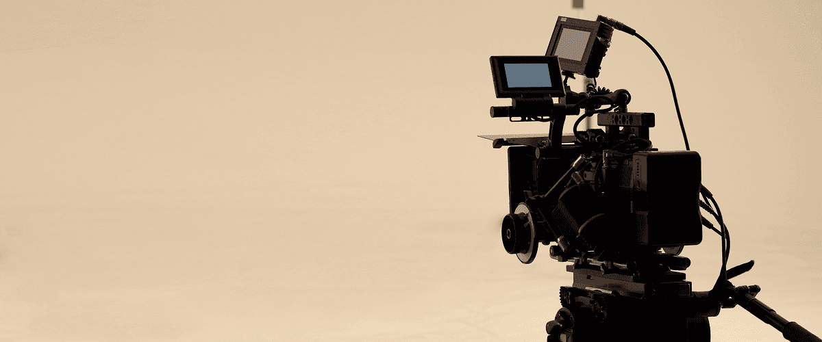 A close-up of a professional video camera in a studio, representing why professional video production is key to business growth in 2025.