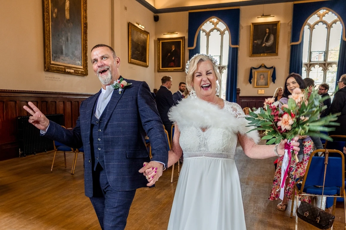 Bride and groom walking down the aisle smiling during wedding ceremony