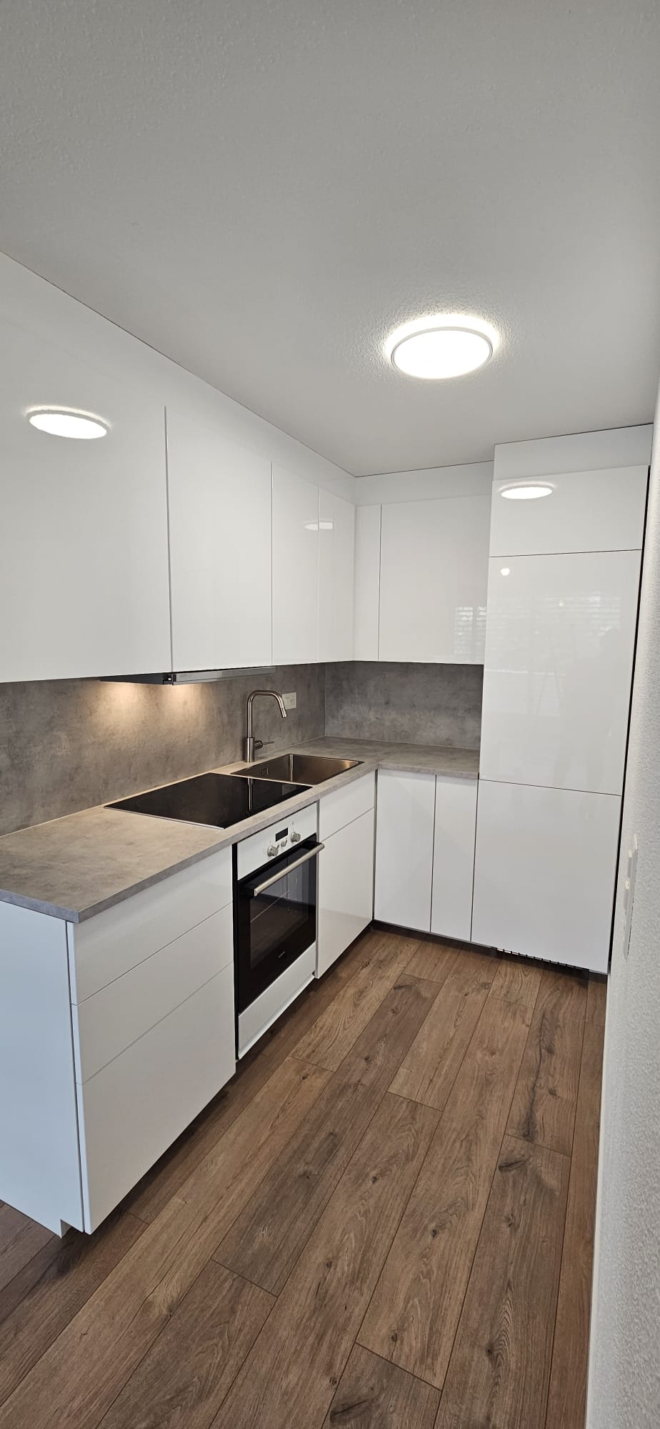 Gray modern farmhouse with ivy, a pool, and lounge chairs in a grassy area.