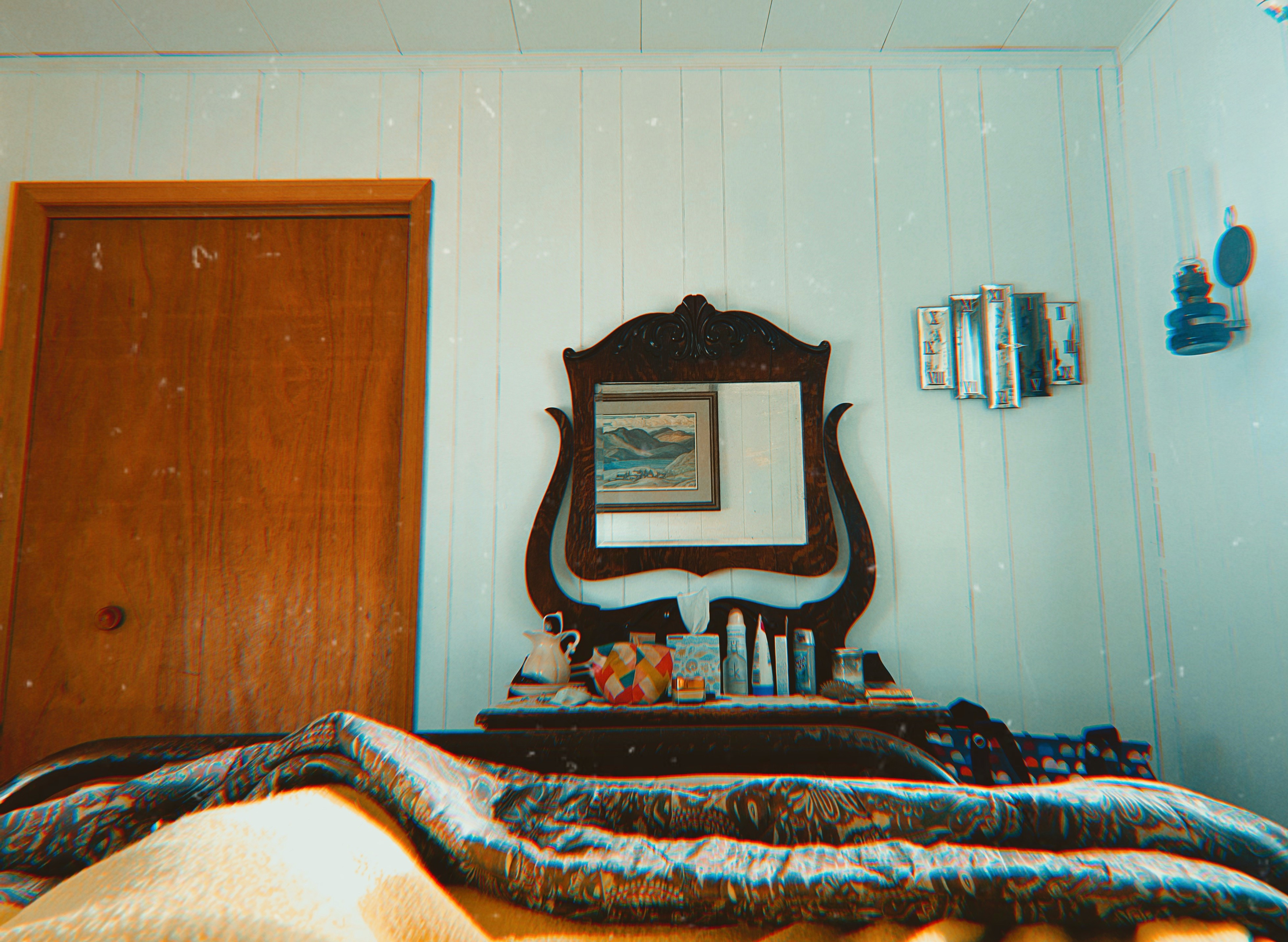 Bedroom with a unique wall decor and a vintage mirror.