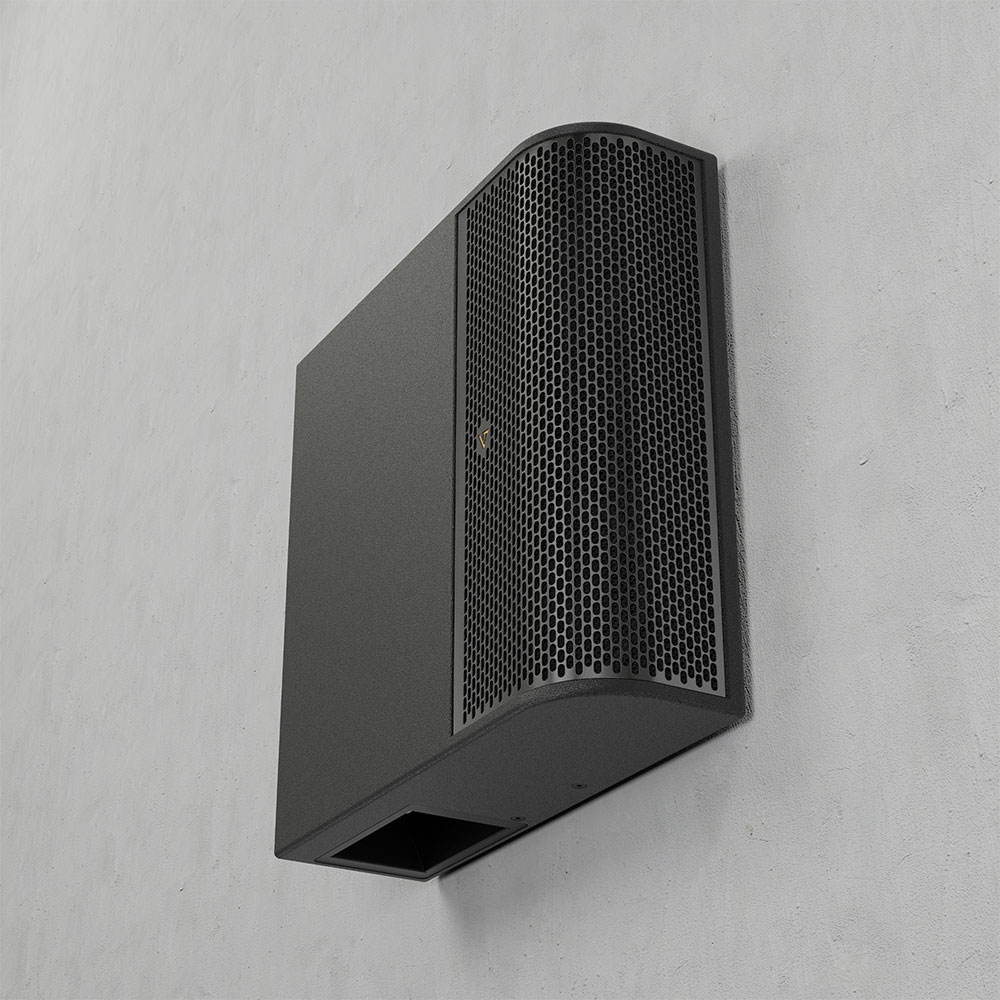 Black speaker mounted on a textured wall.