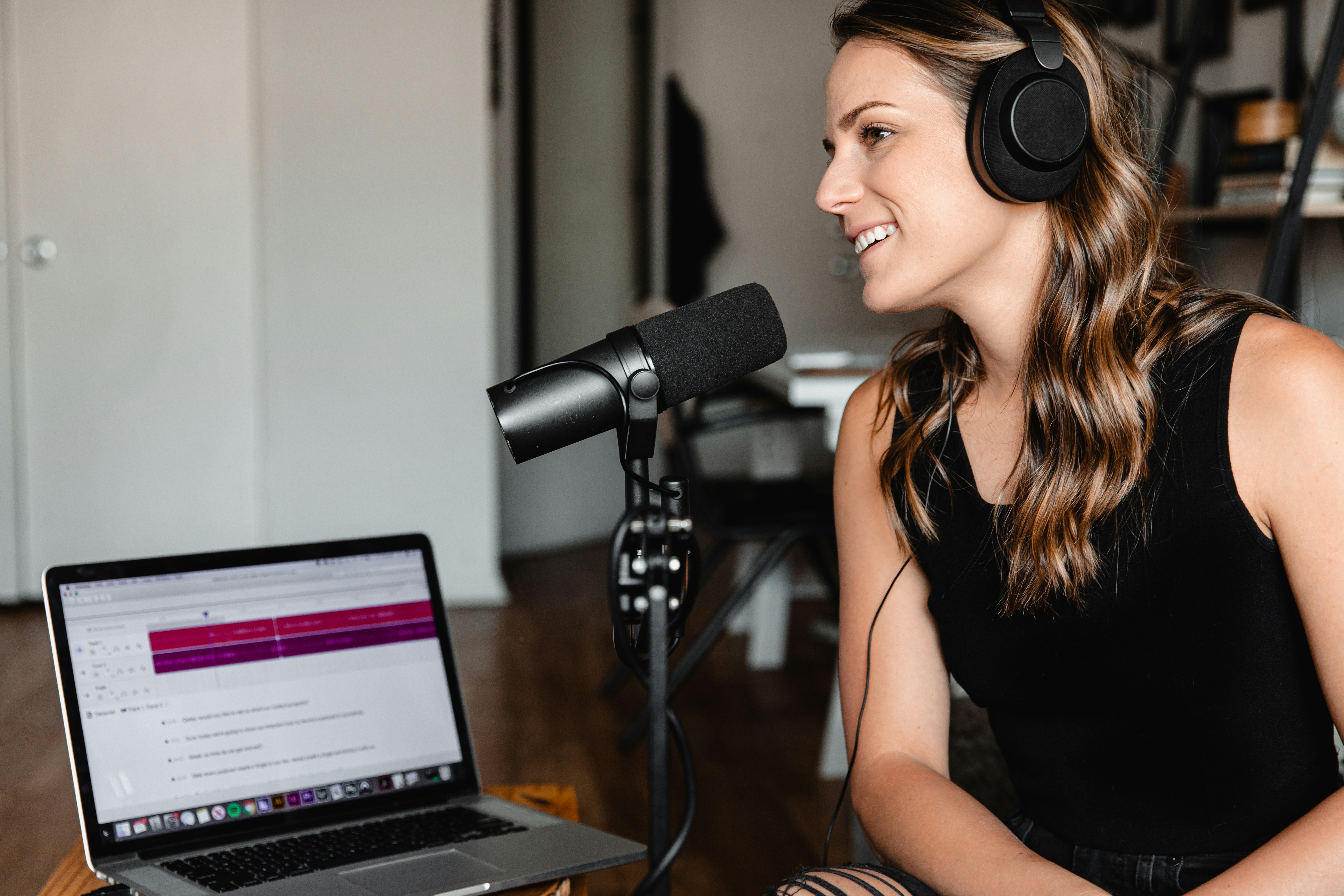 Woman with headphones in a podcast studio