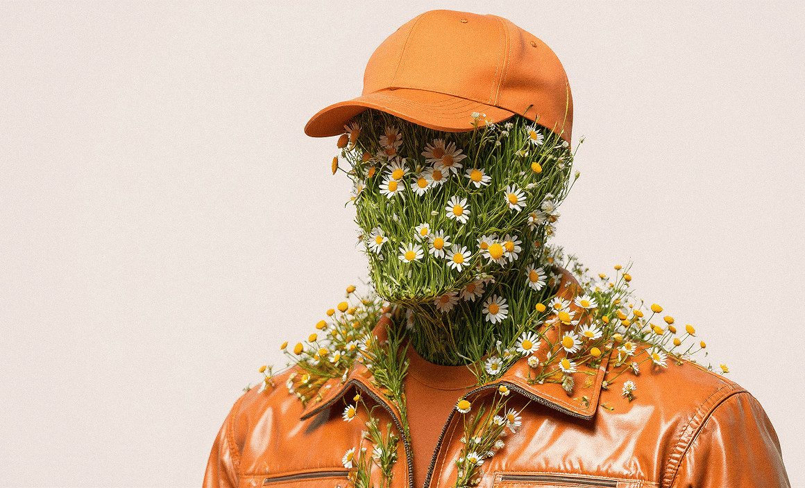 A surrealist digital artwork of a person wearing an orange baseball cap and a glossy orange leather jacket. Their entire face and neck are composed of thick green grass and numerous blooming white daisies with yellow centers, creating a floral humanoid appearance against a neutral beige background
