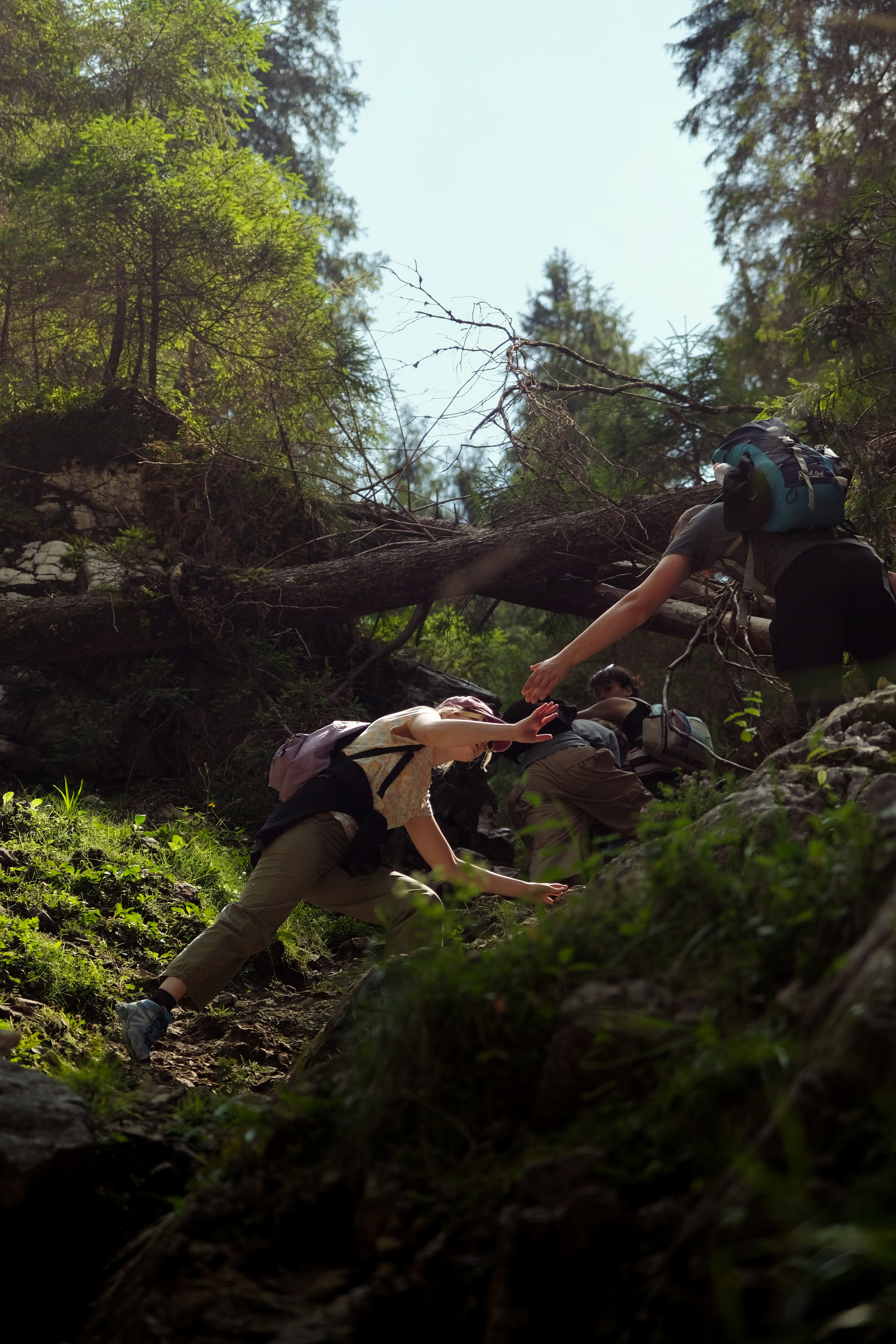 A person climbing up a hill with a backpack