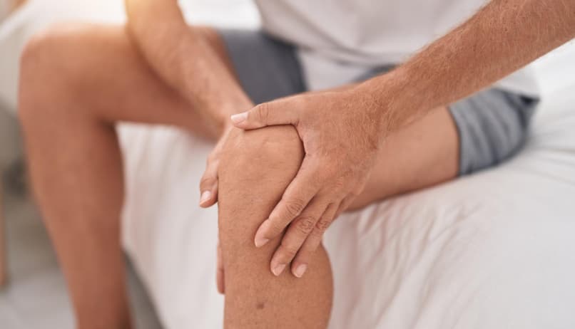 Чоловік тримається за коліно