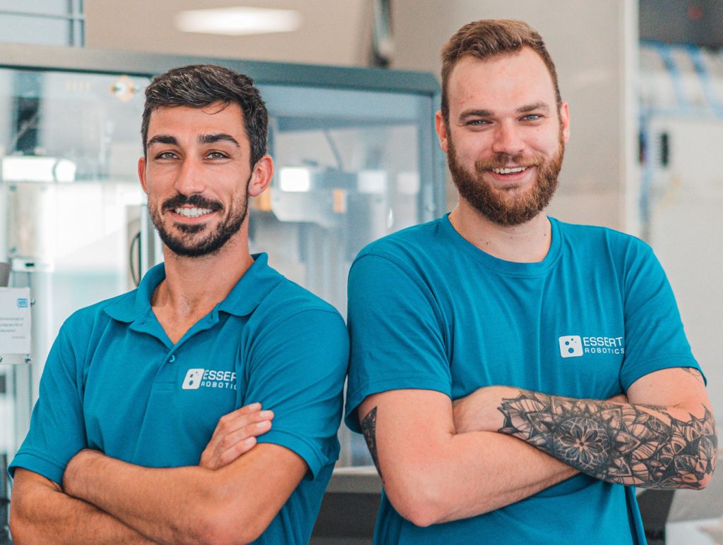 Two ESSERT Robotics Team Members. In the background an automation module.