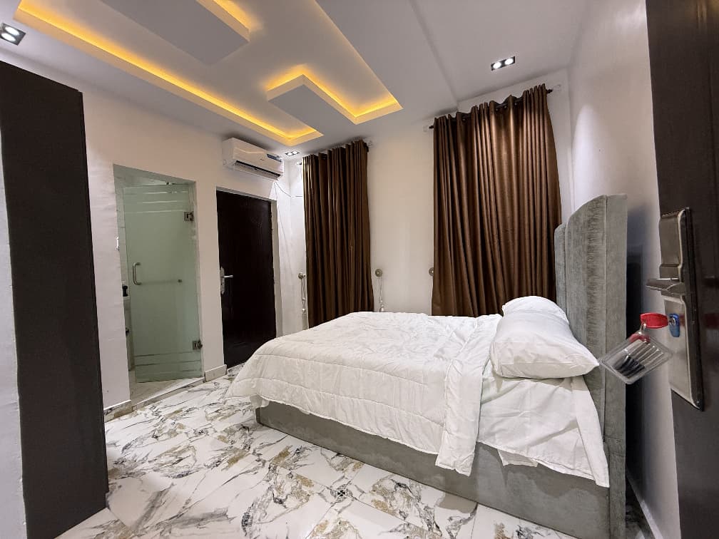 Spacious bedroom interior at Cedar The Crest, modern shortlet apartment in Yaba, Lagos