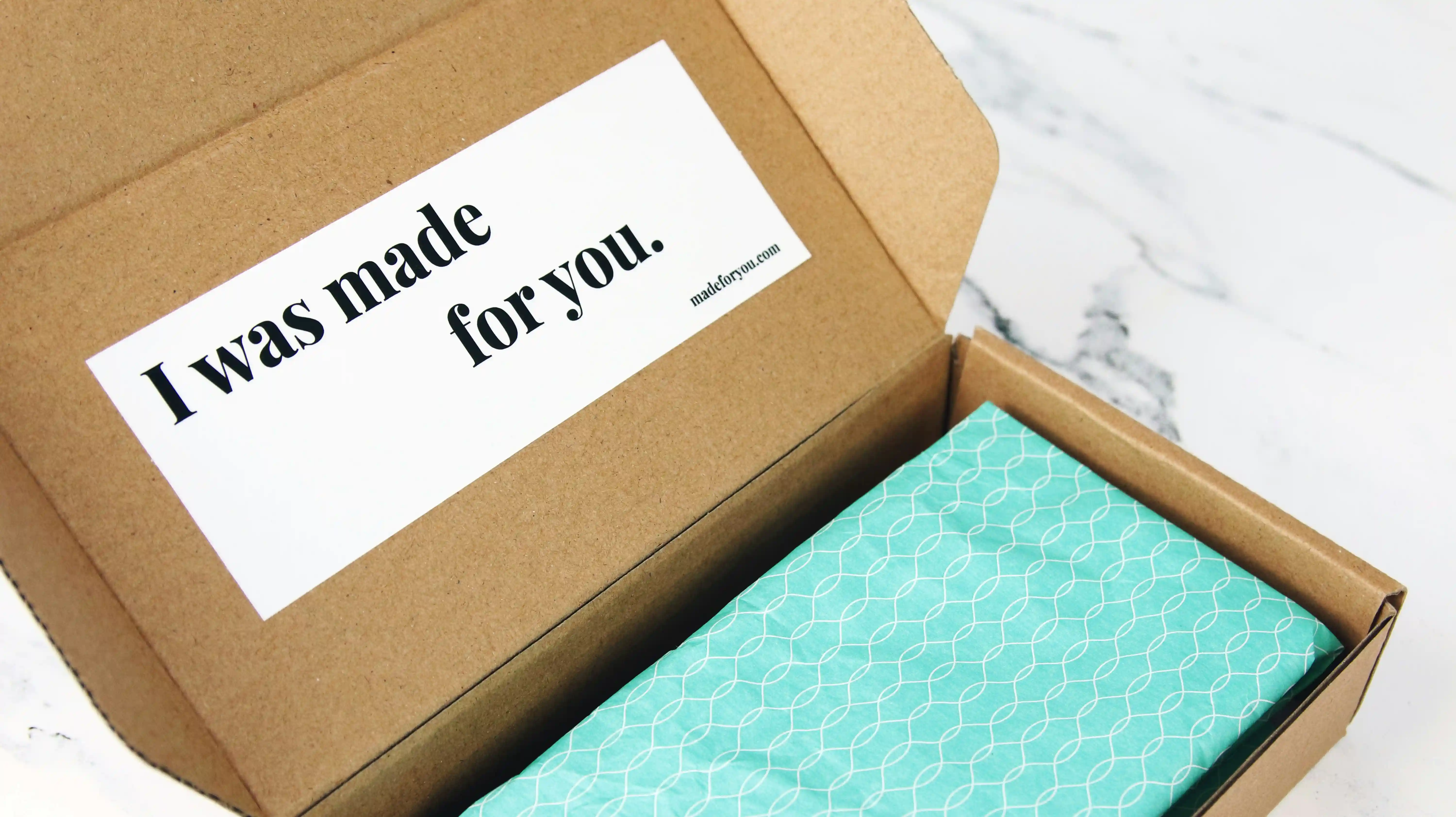 An open parcel with the words "I was made for you." written on the inside of the lid