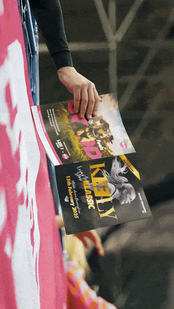 Model walking through a wheat field with a distant gaze.