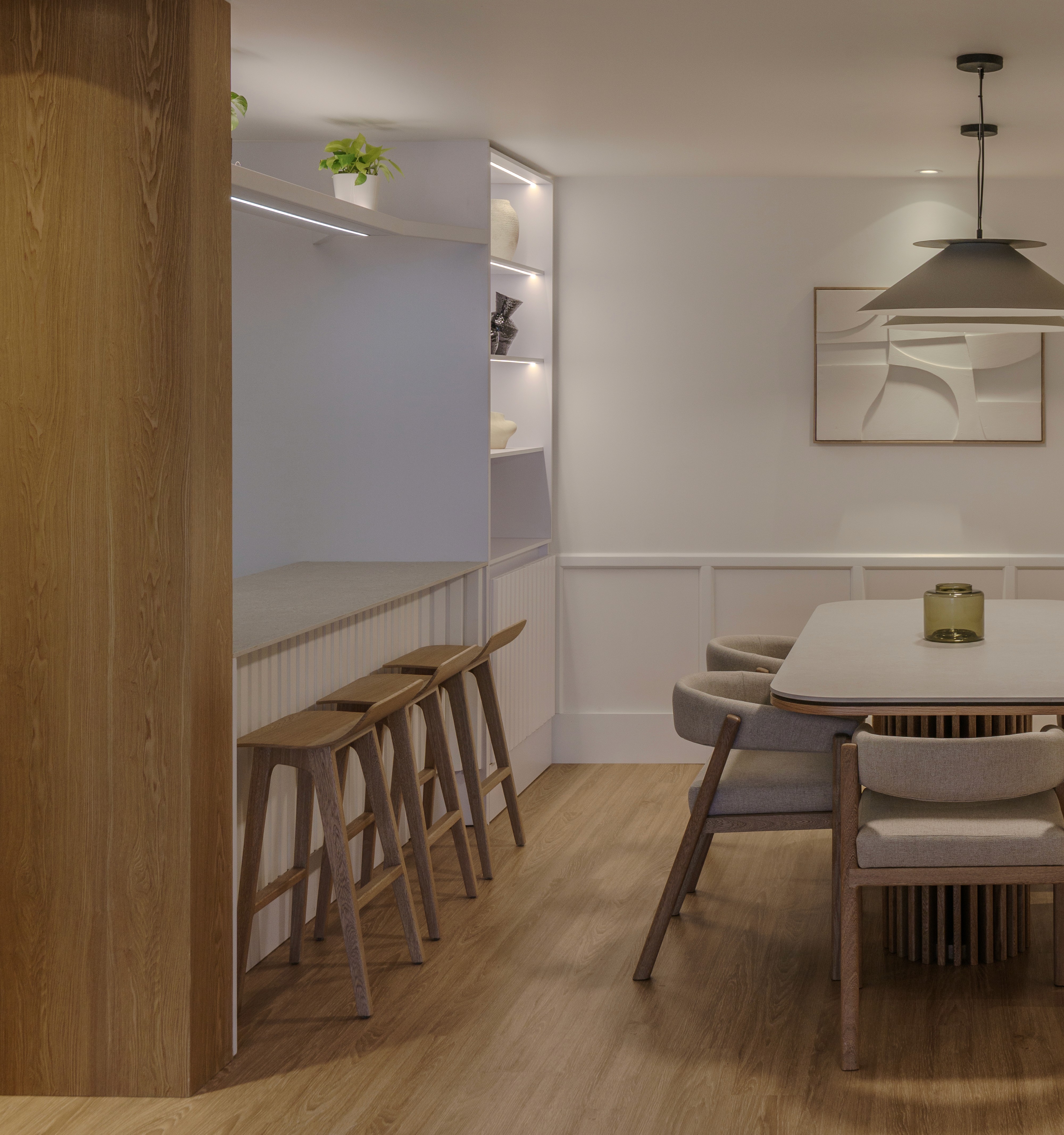 Double-height interior with flowing sculptural forms and warm raking light