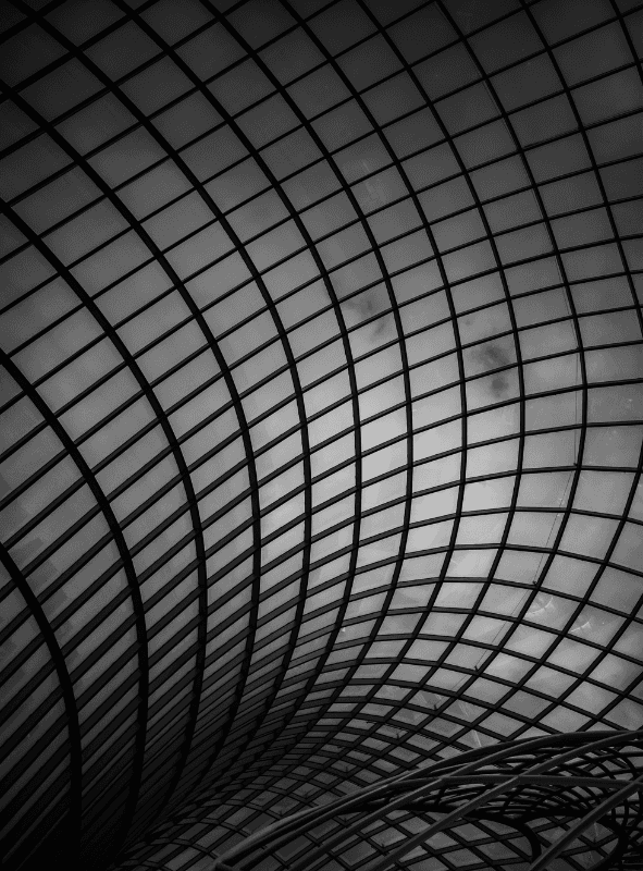 Minimalist light-wood kitchen with a white island, three mustard bar stools, and soft warm lighting.