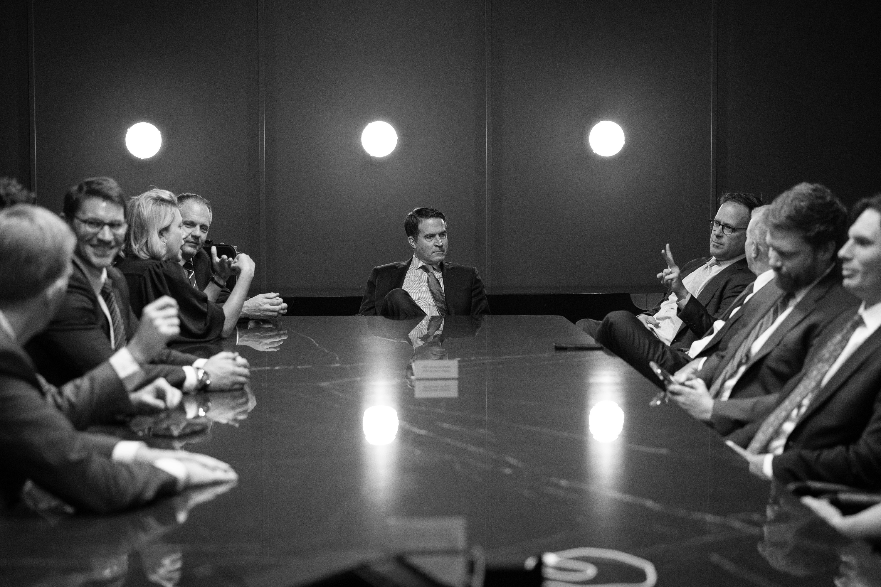 man talking to table of collegues