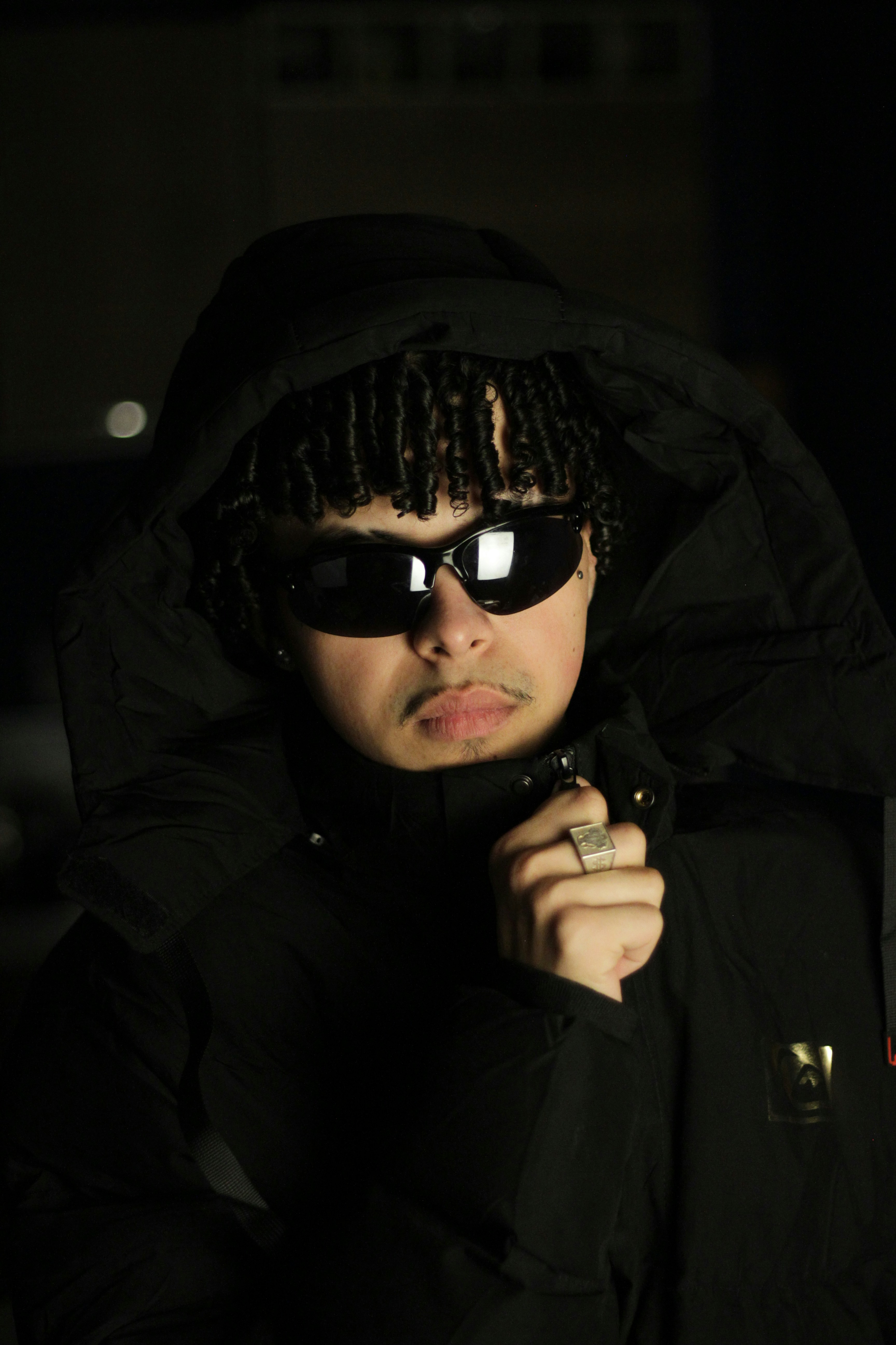 A person in sunglasses and a black hoodie.
